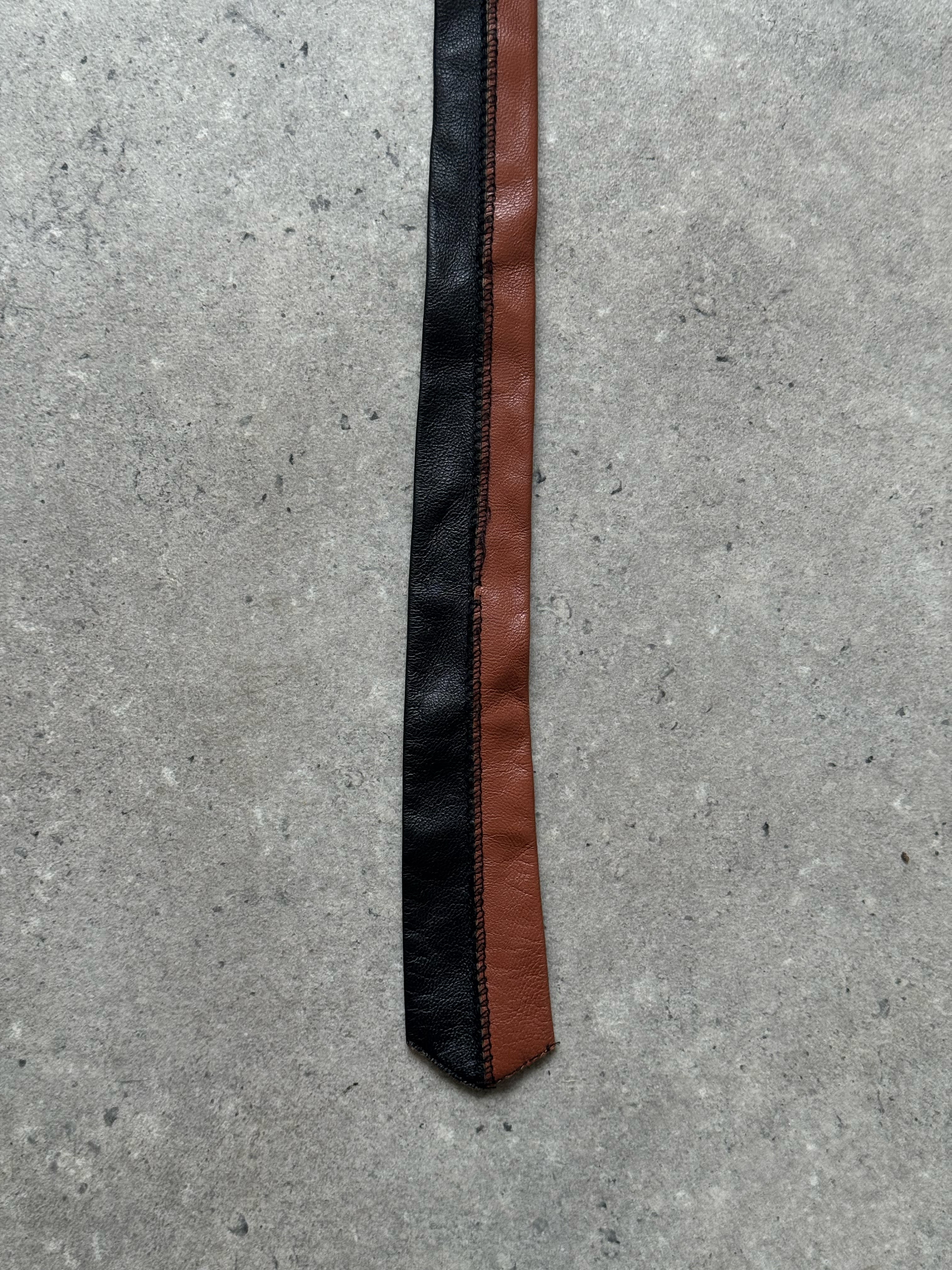 Vintage 2000s two-tone leather skinny tie, stylish accessory with contrasting shades, perfect for vintage fashion looks.