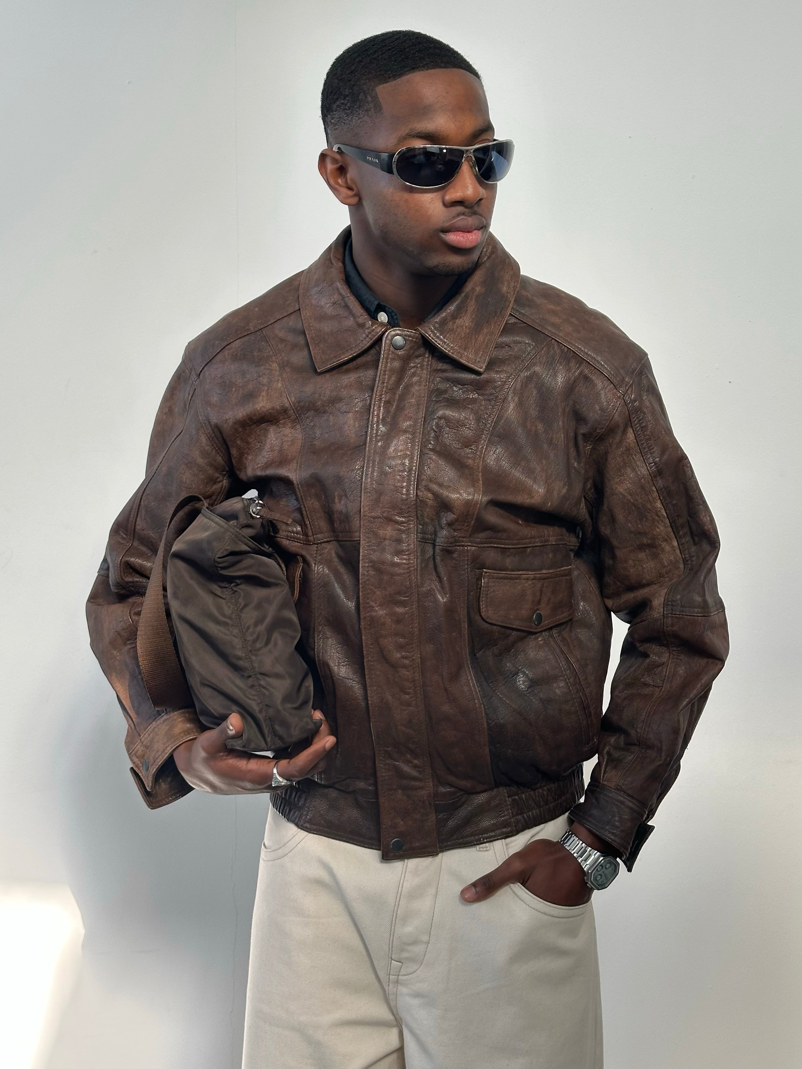 Vintage 1990s distressed leather bomber jacket, men's size M, with a rugged, worn-in look and classic style.