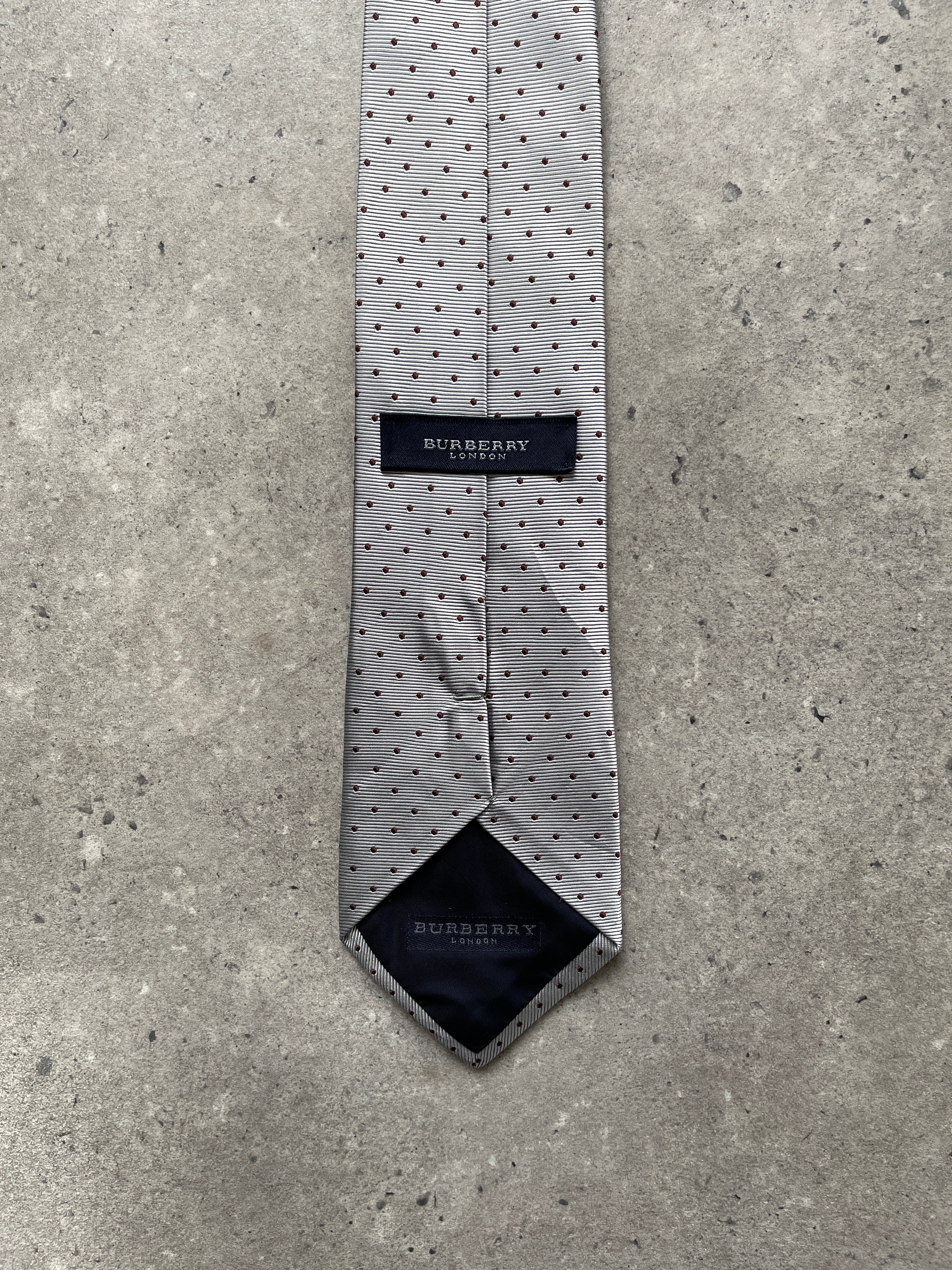Burberry London 2000s pure silk polka dot tie displayed flat, showcasing its classic design and elegant fabric texture.