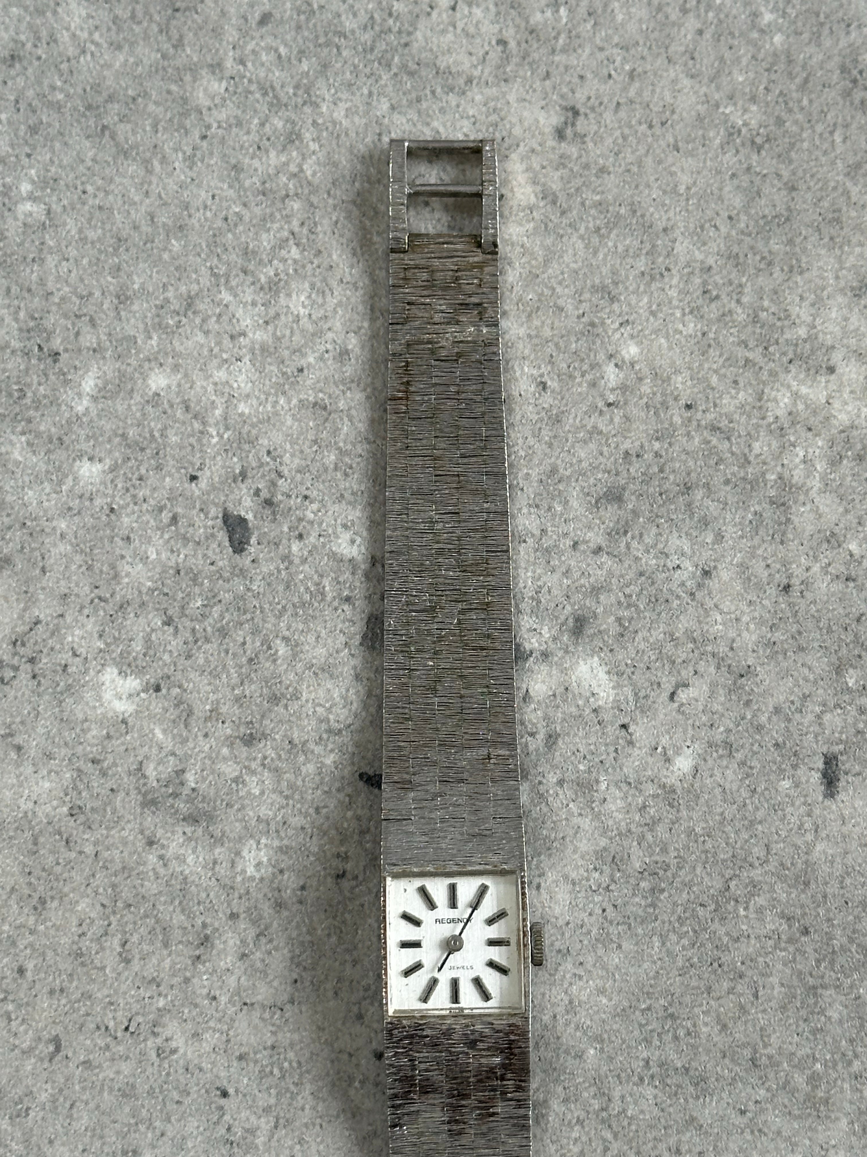 Vintage 1970s stainless steel square dial watch with minimalist design and metallic finish, showcasing a classic vintage timepiece.