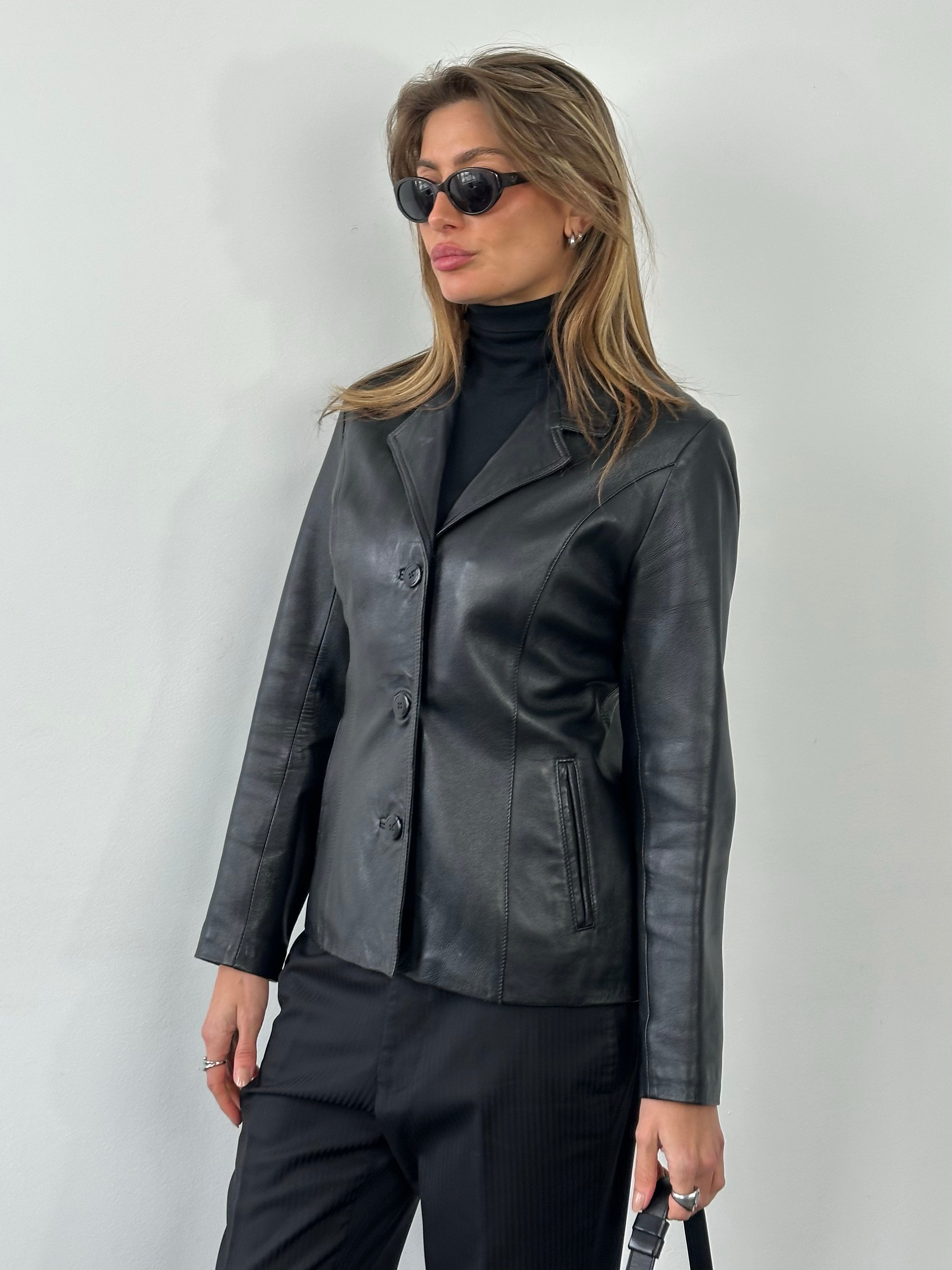 Vintage 1990s fitted leather jacket in classic brown leather, featuring a sleek design and zip-up closure.