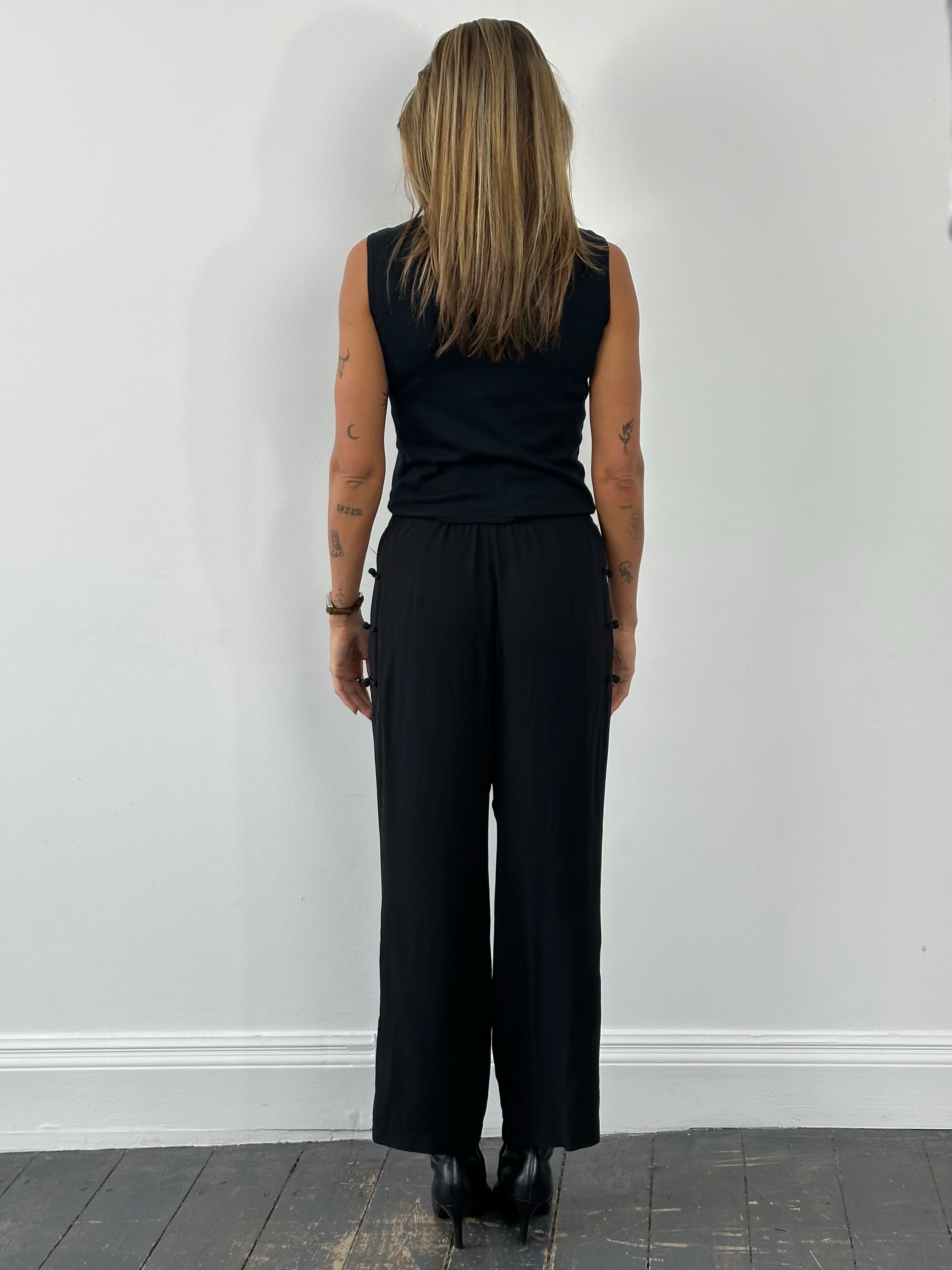 Vintage 1990s pure silk wide-leg trousers in size W28, showcasing smooth fabric and relaxed fit.