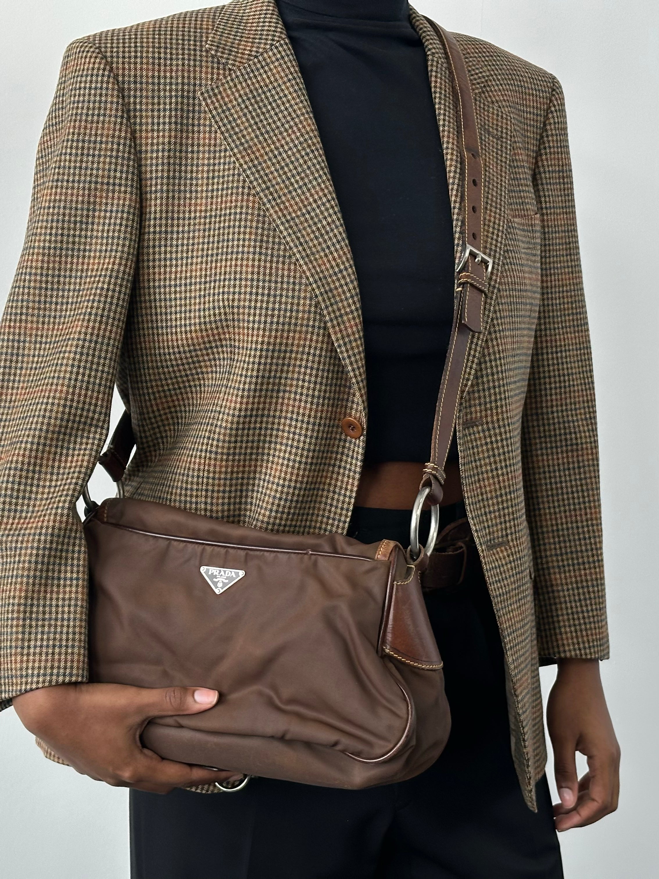 Prada 1990s nylon crossbody bag with adjustable strap and sleek design, featuring the iconic Prada logo and minimalist style.