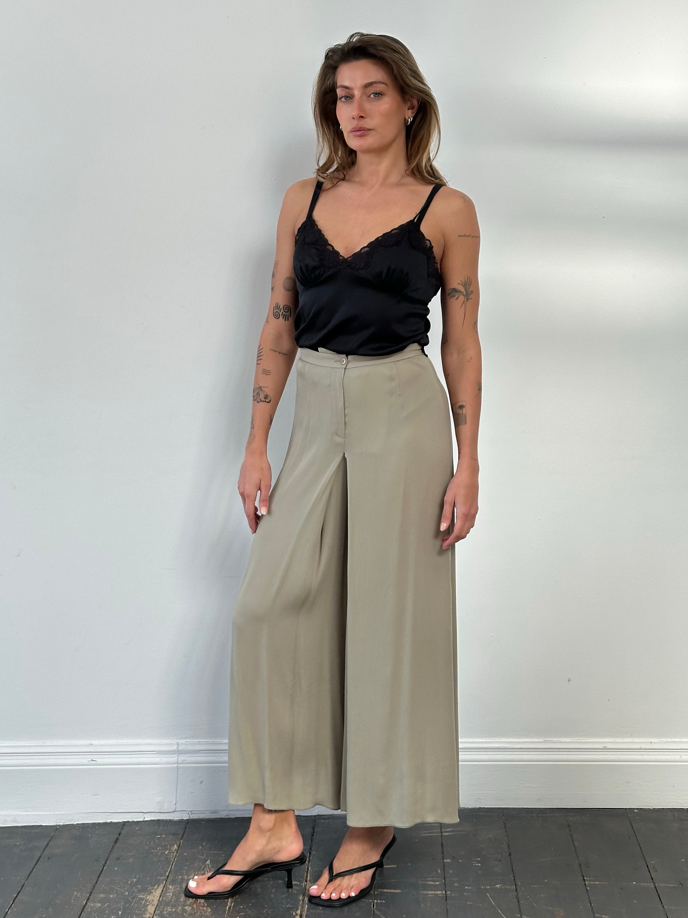Armani Collezioni 2000s silk wide-leg pleated trousers in cream with W26 waist, shown flat with fold detail.