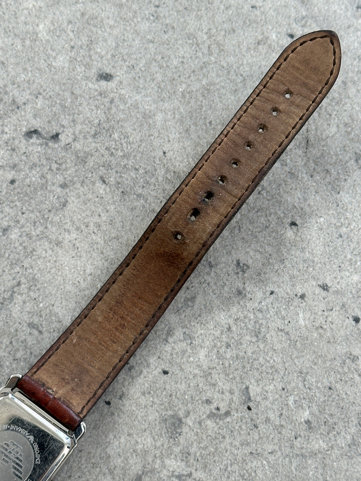 Emporio Armani 2000s leather rectangular quartz watch with black dial and silver case, showcasing a sleek, modern design.
