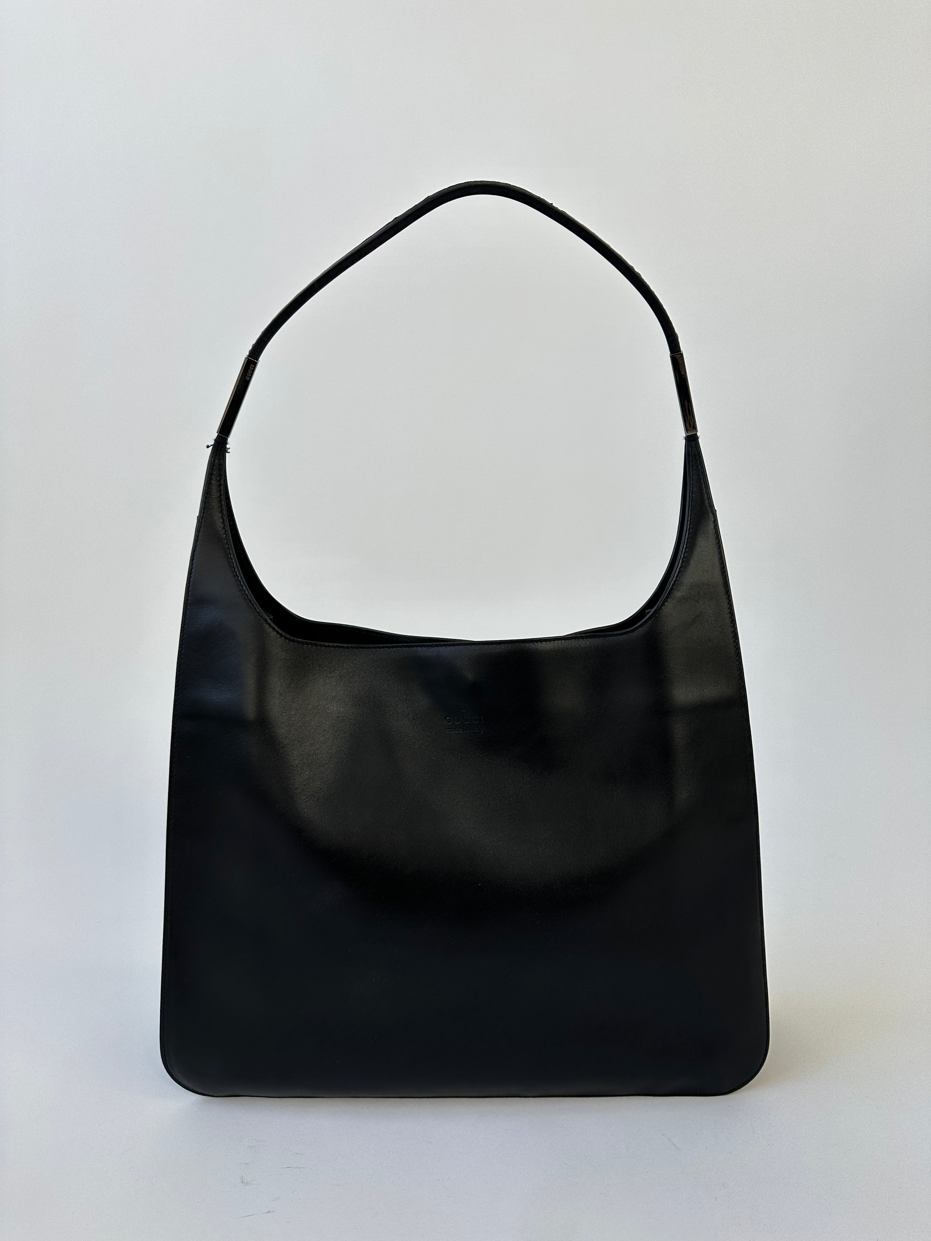 Gucci leather shoulder bag featuring a sleek design, adjustable strap, and signature branding, perfect for stylish everyday use.