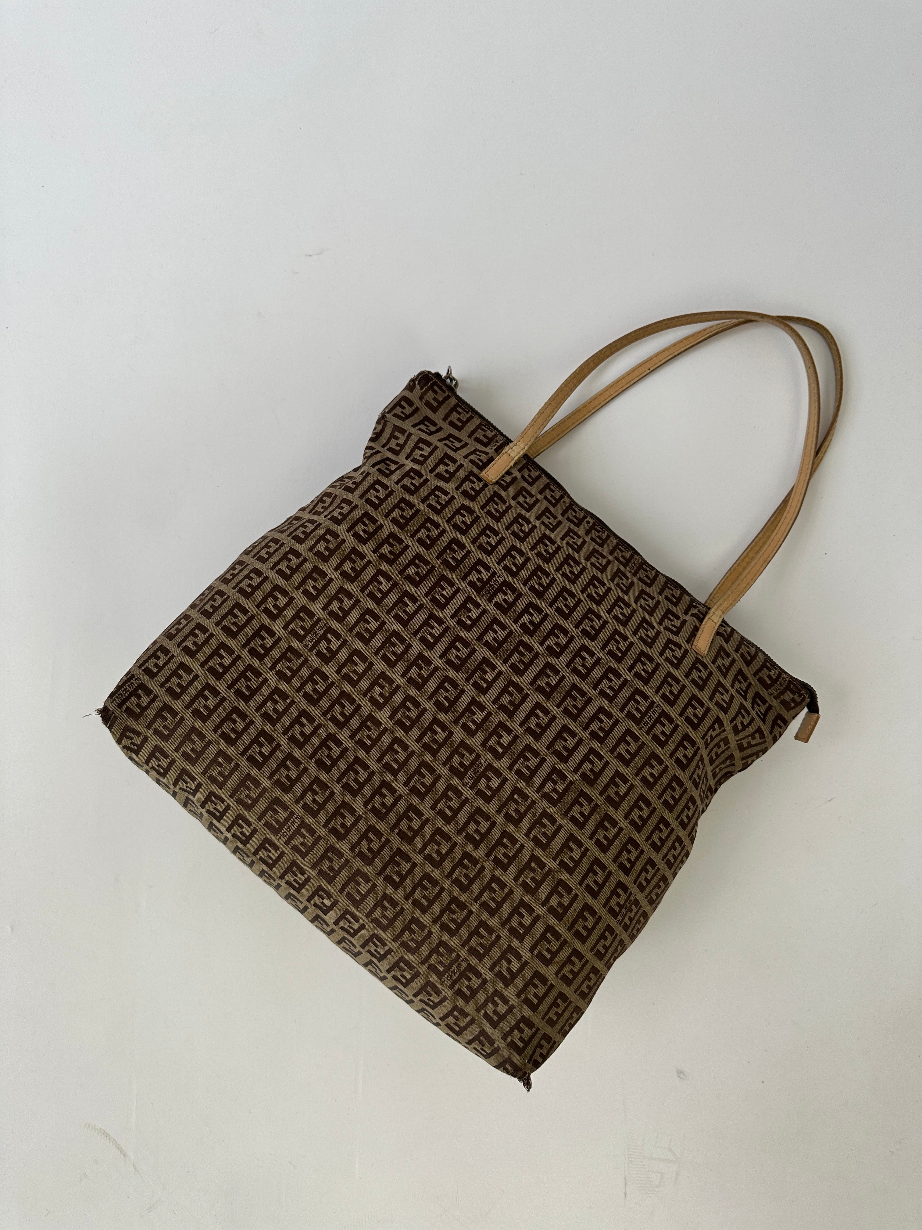 Fendi FF Monogram shoulder bag with adjustable strap and gold-tone hardware, featuring iconic branded monogram pattern.
