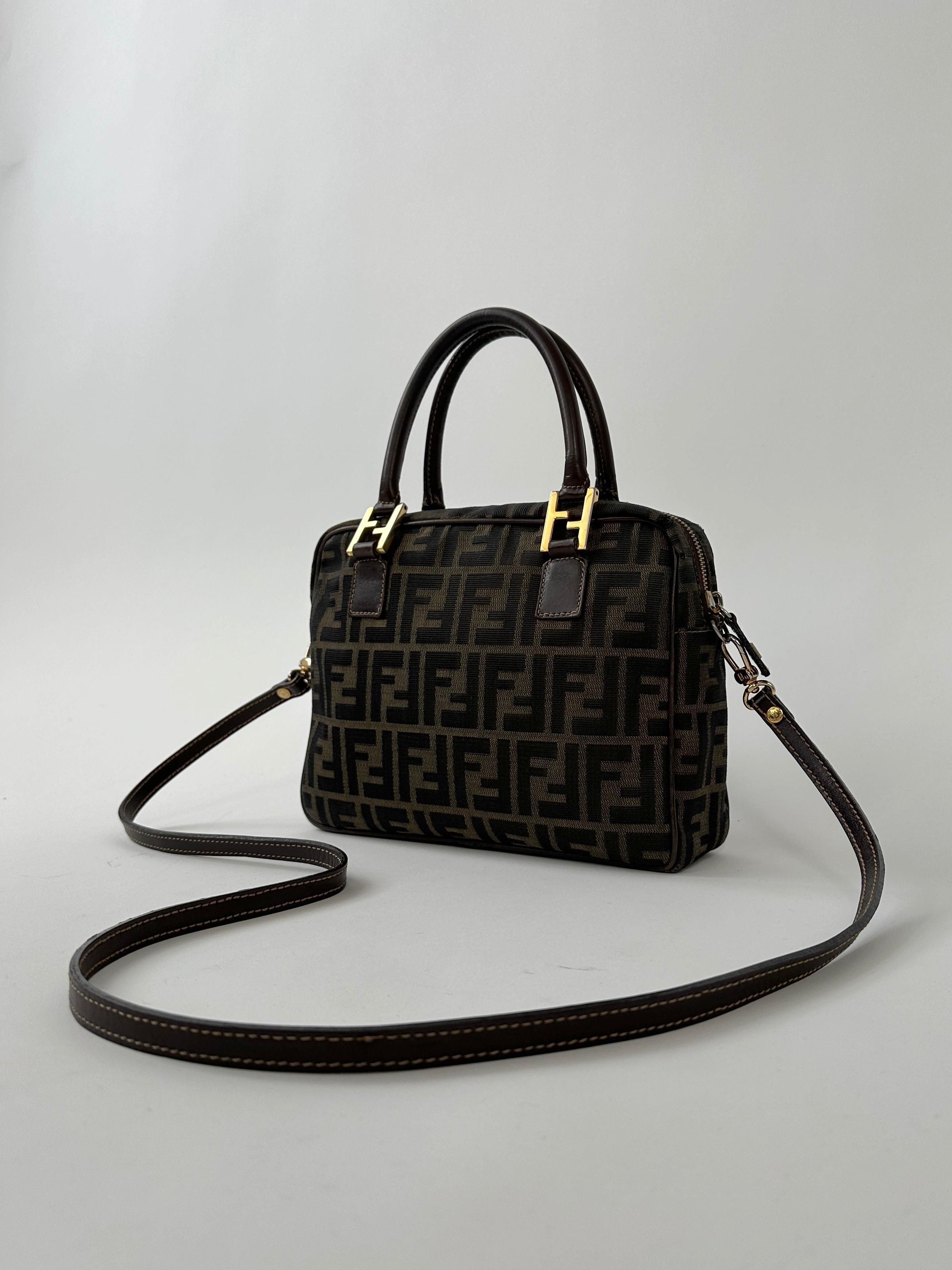 Fendi Zucca Monogram crossbody bag with adjustable strap and leather accents, featuring the iconic Fendi monogram pattern.