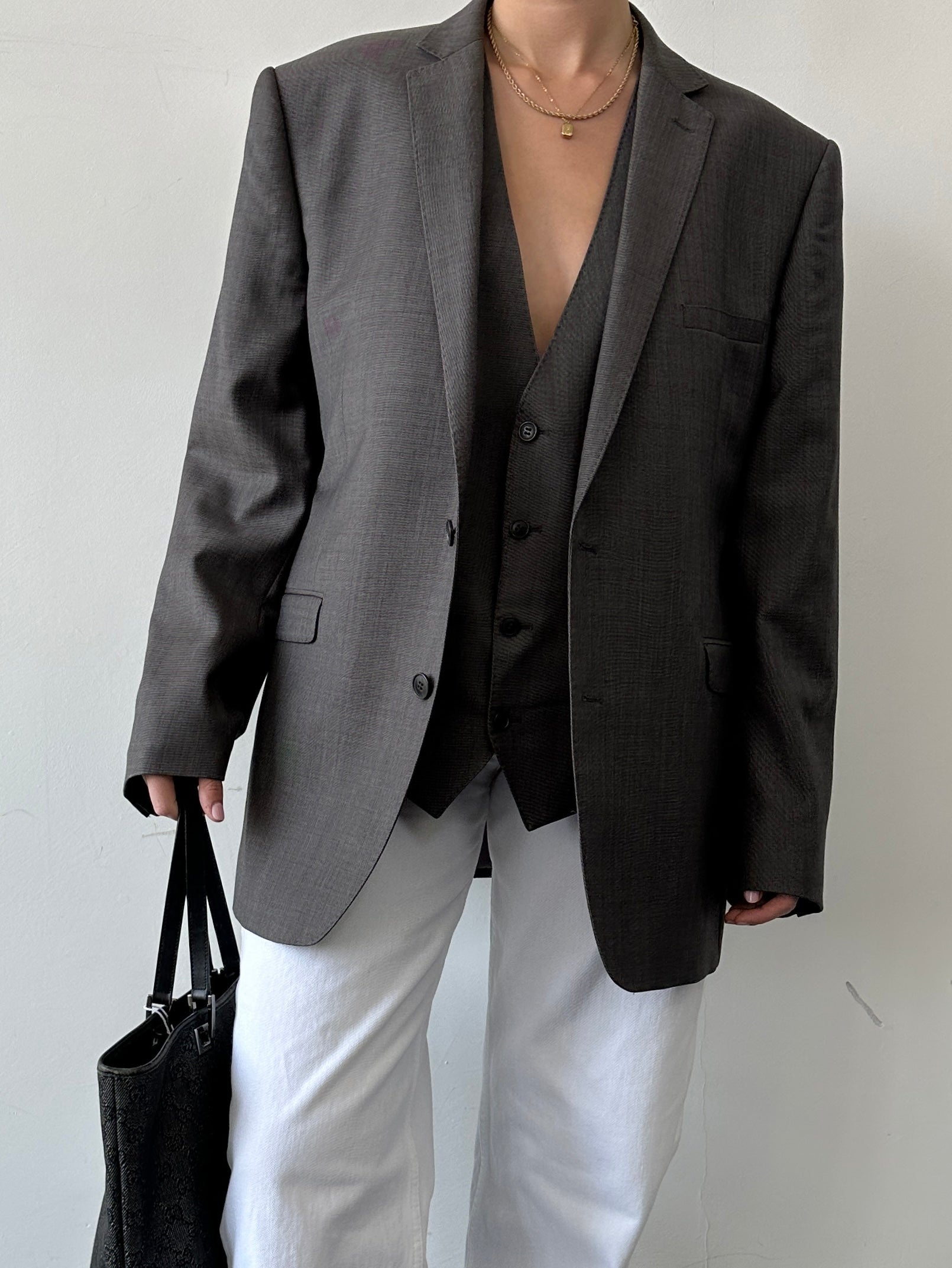 Vintage single-breasted wool blazer from a two-piece suit, size 44/XL, featuring classic tailored design and rich fabric texture.