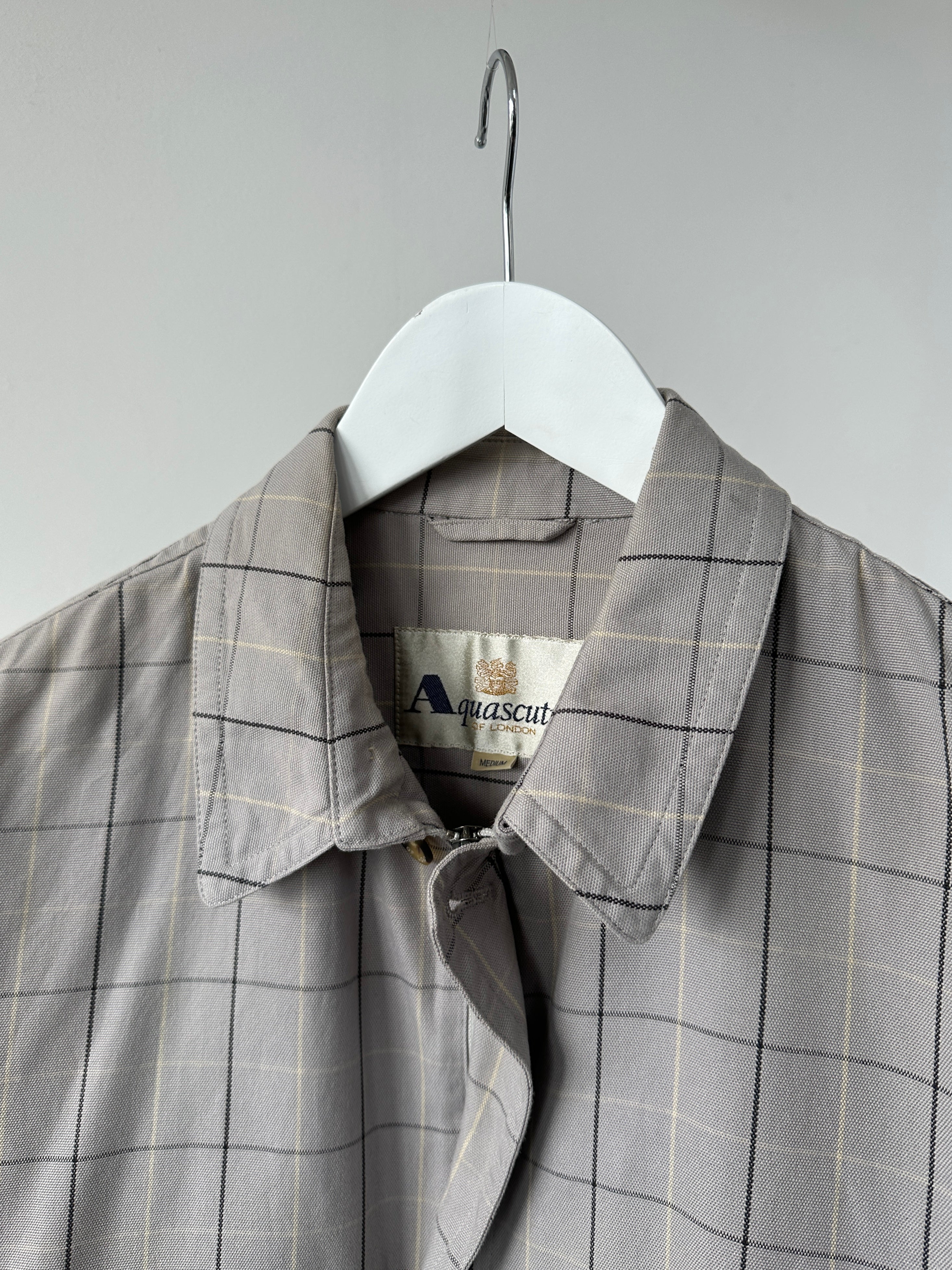 Aquascutum check cotton bomber jacket in size S, featuring a classic pattern and casual fit, shown on a hanger.
