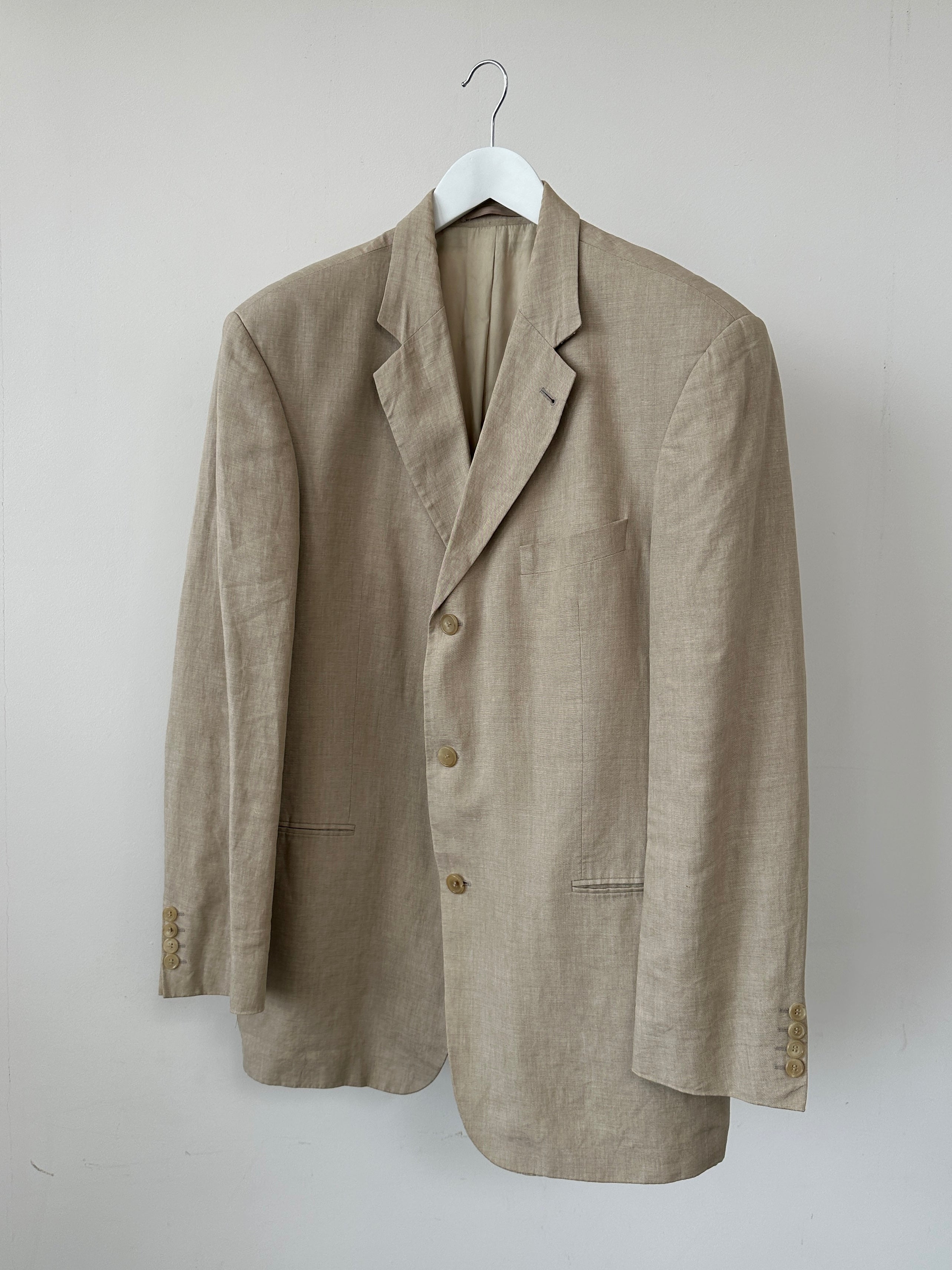 Hugo Boss boxy pure linen single-breasted blazer in XL, displayed on a hanger, showcasing its tailored fit and lightweight fabric.