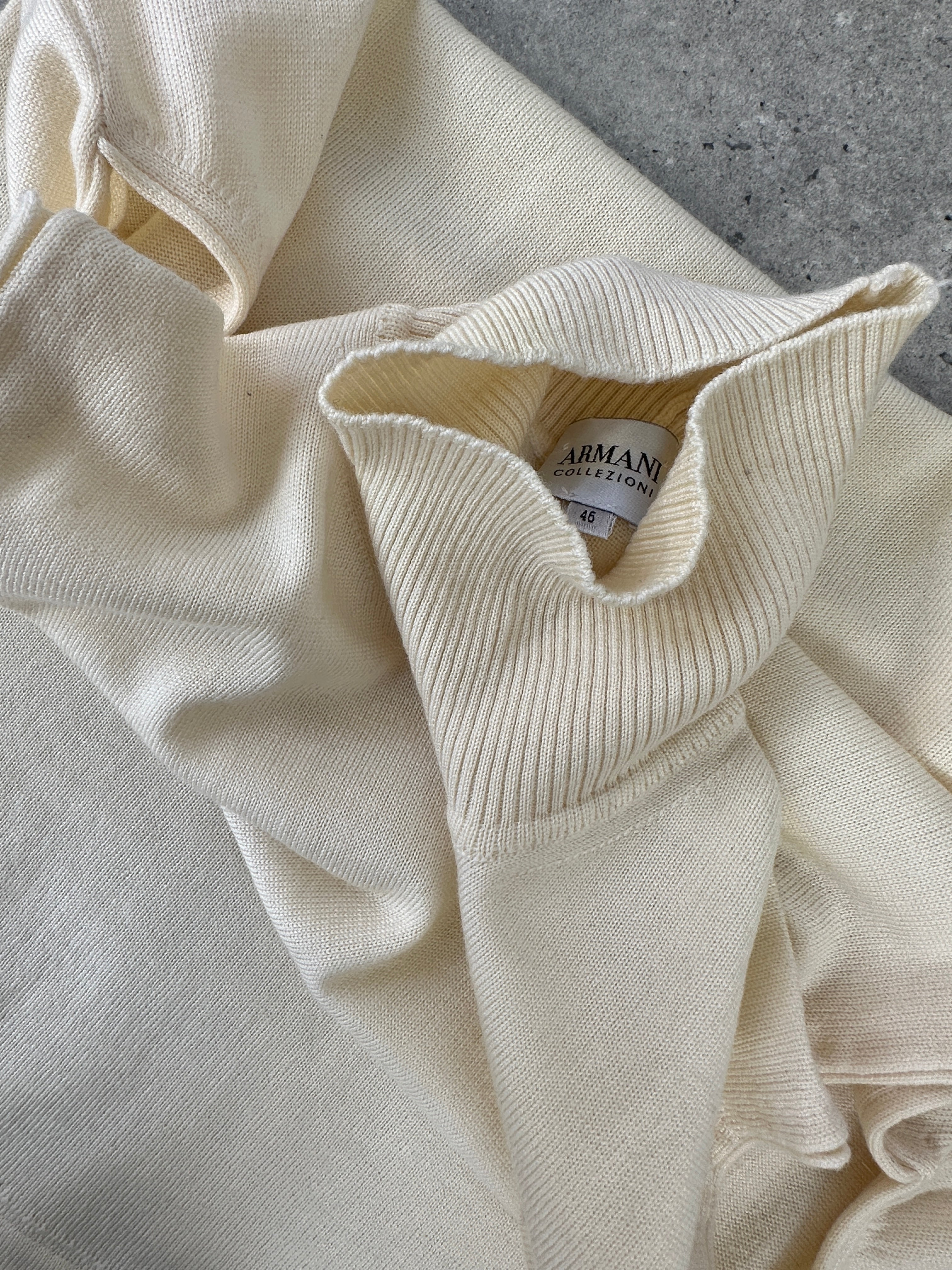 Armani Collezioni sleeveless turtleneck jumper in soft virgin wool, featuring a fitted silhouette and classic turtle neck design.