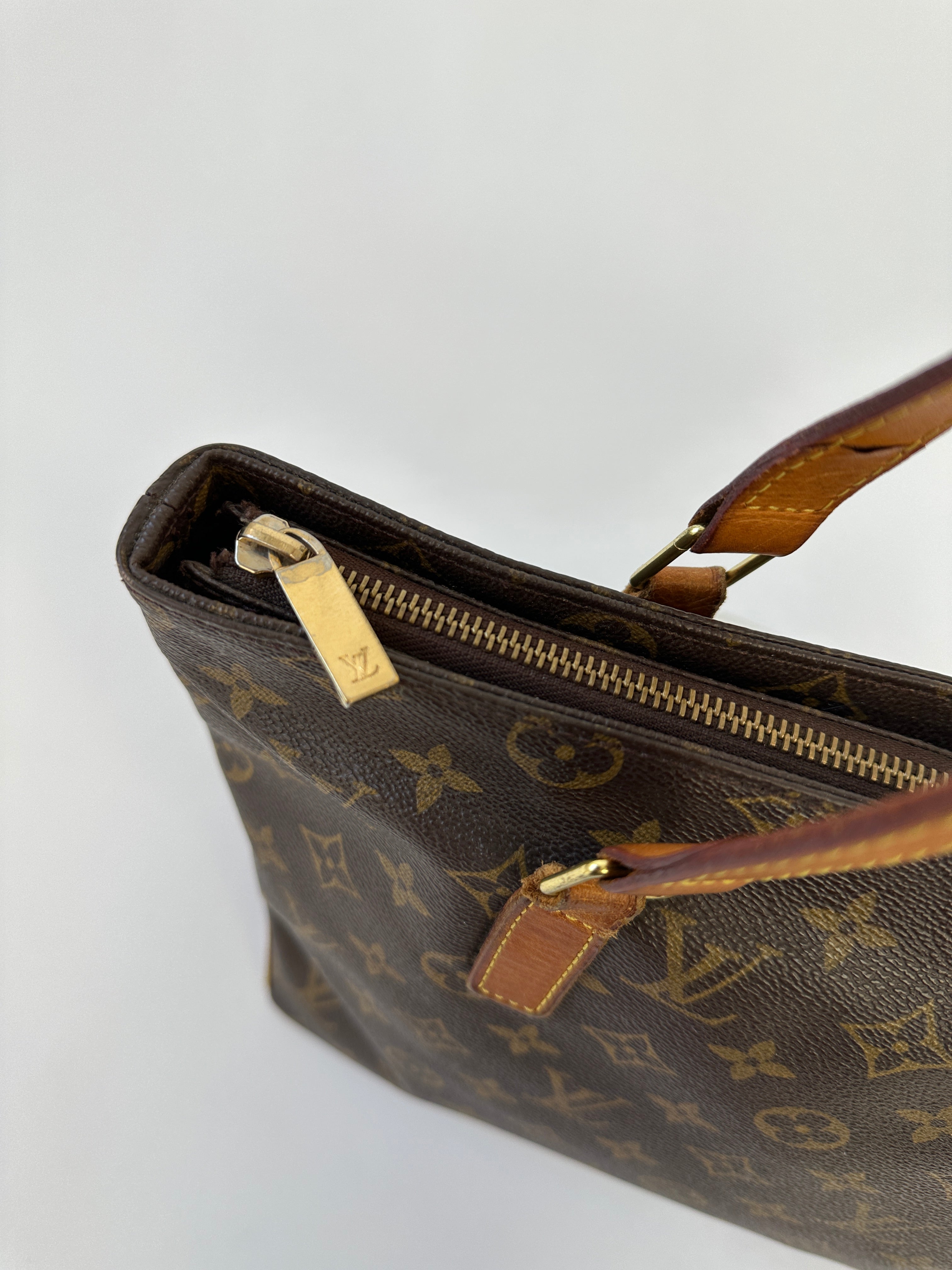 Louis Vuitton 2002 Cabas Mezzo Monogram shoulder bag with leather handles and monogram canvas, lying flat on a neutral background.
