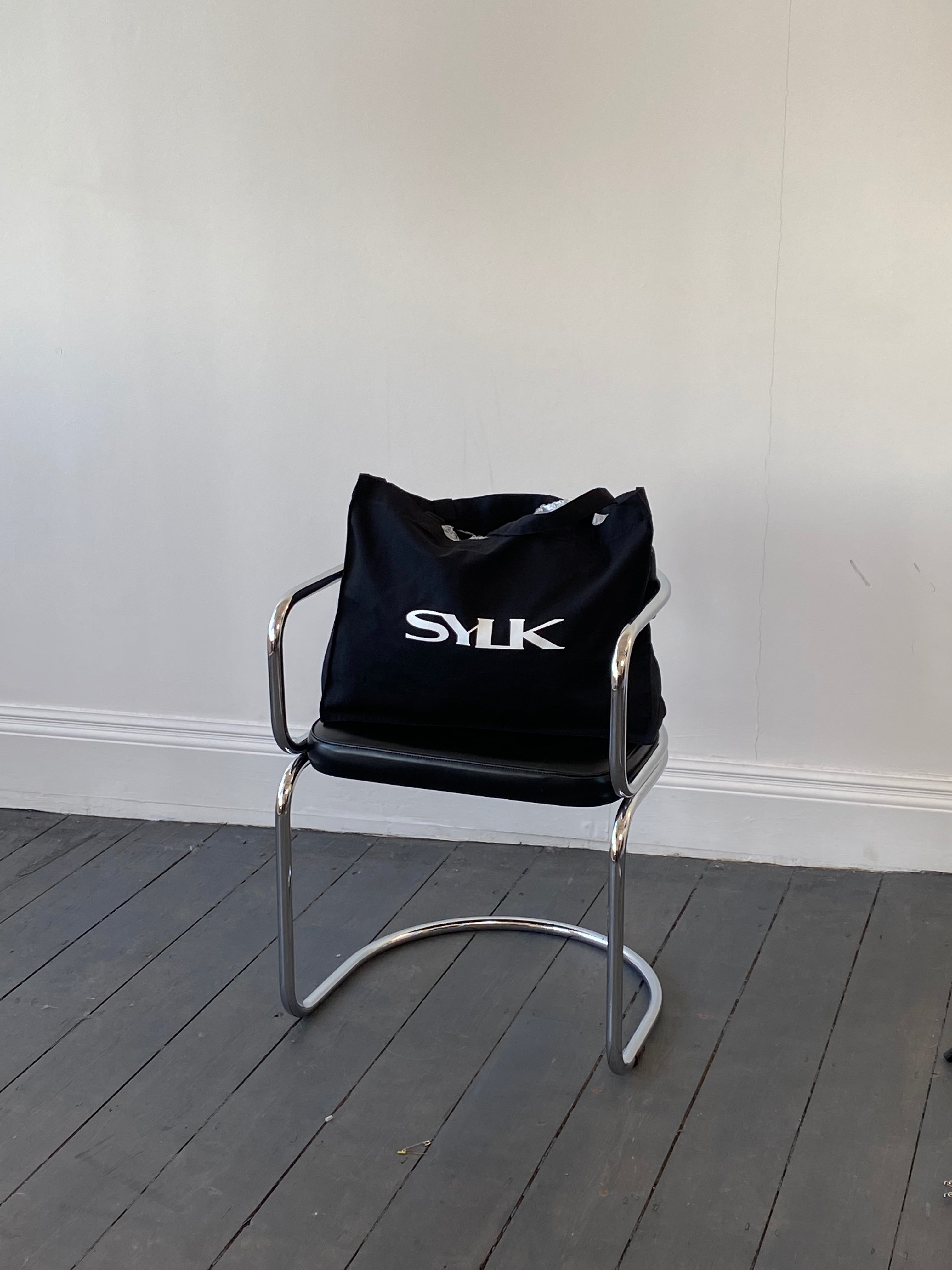 SYLK recycled cotton tote bag with natural handles and spacious interior, showcasing eco-friendly reusable shopping bag design.