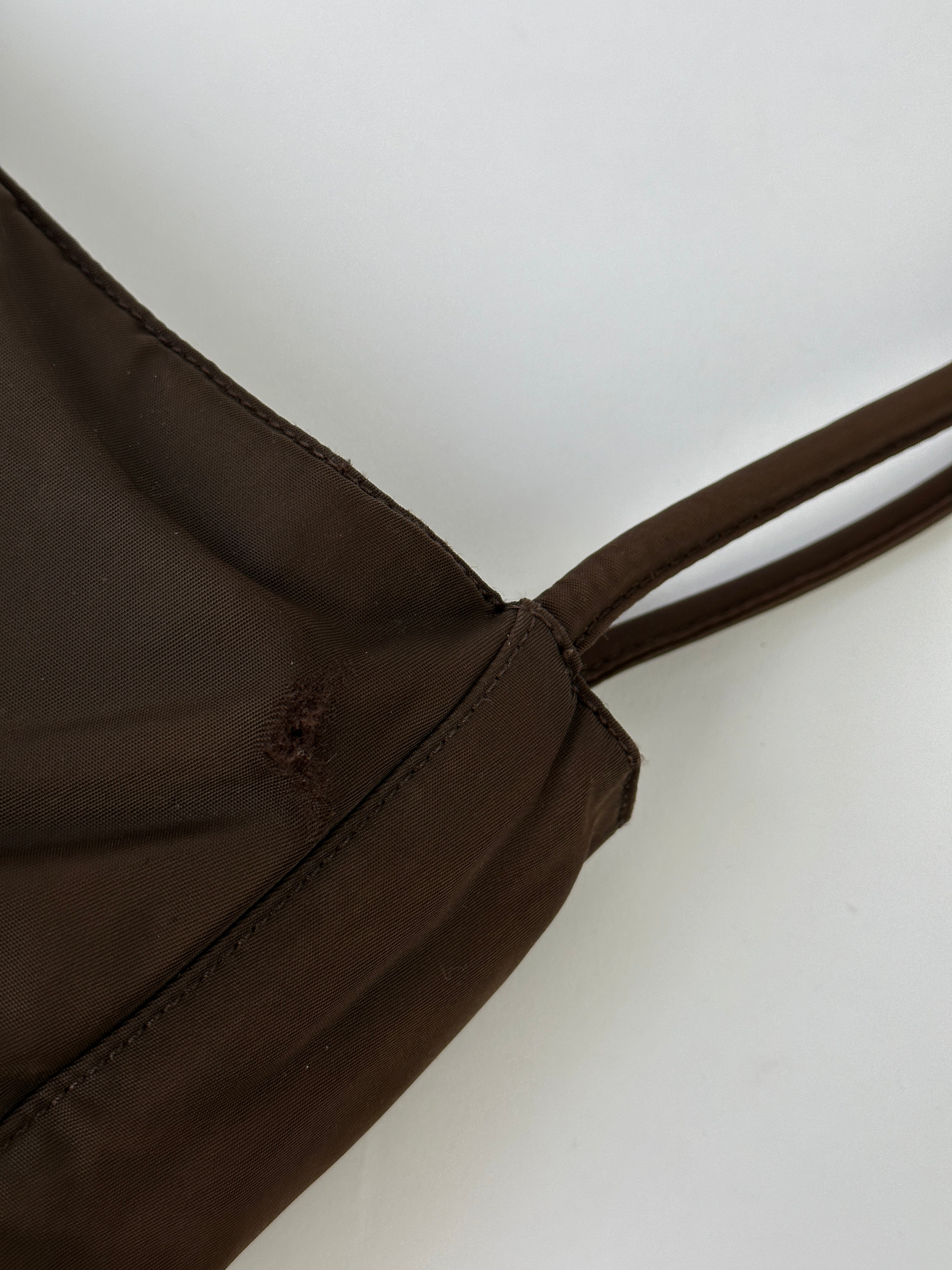 Prada Tessuto nylon tote bag with sleek design, featuring handles and spacious interior for everyday carry.