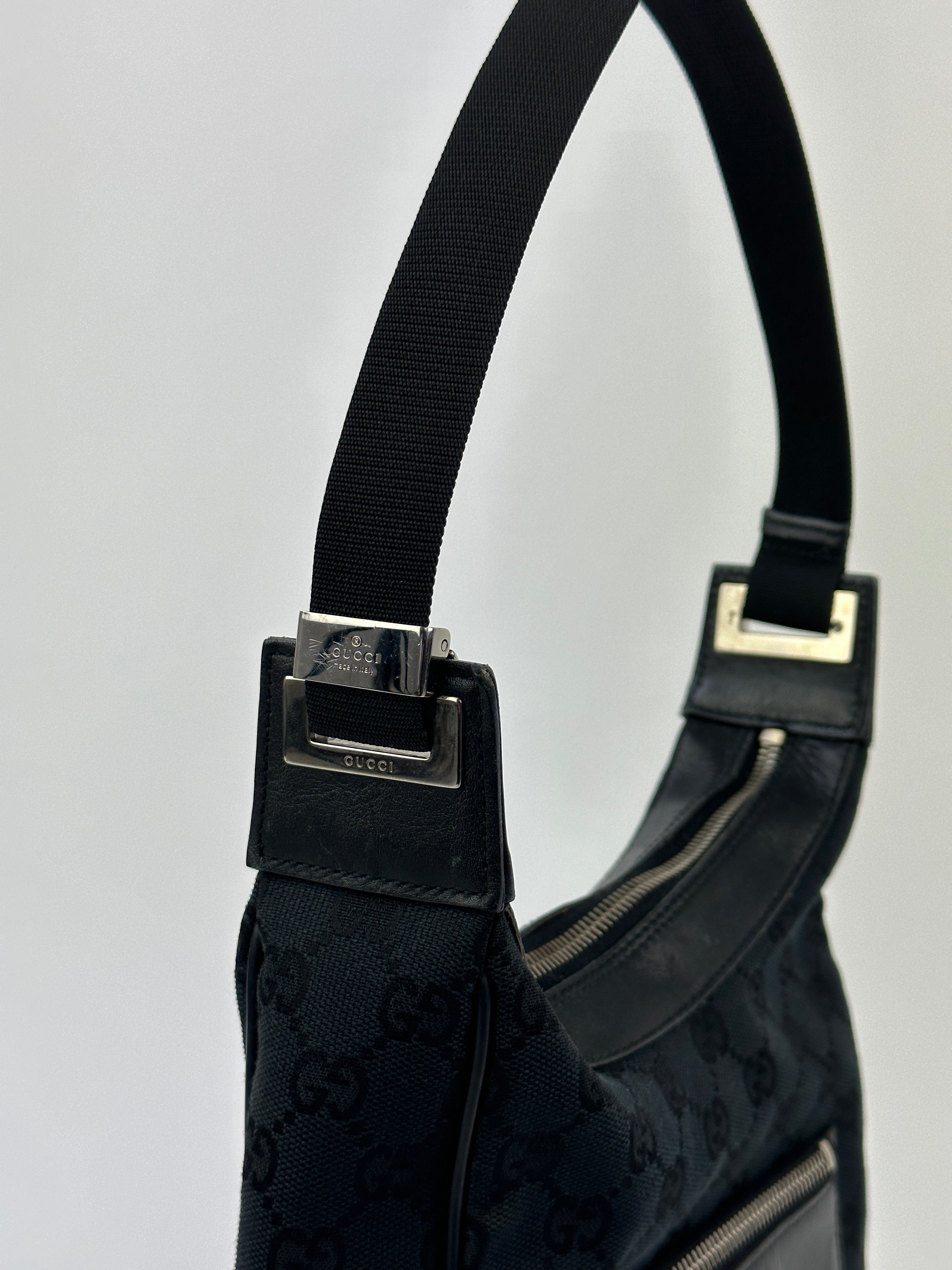 Gucci GG Monogram Canvas Leather Shoulder Bag with adjustable strap and gold-tone hardware, stylish and spacious for everyday use.