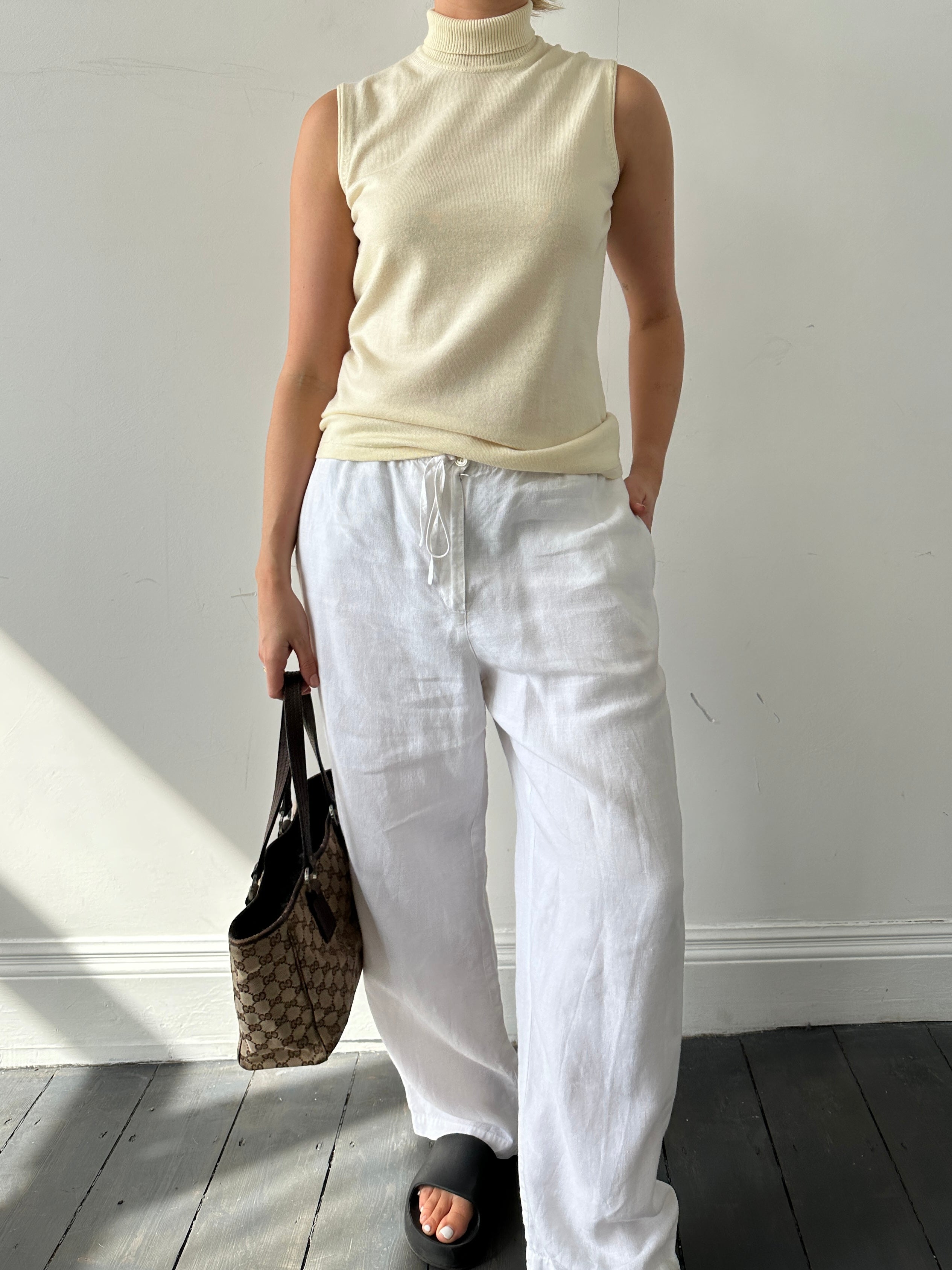 Armani Collezioni sleeveless turtleneck jumper in virgin wool, showcasing a sleek, fitted design in natural wool fabric.