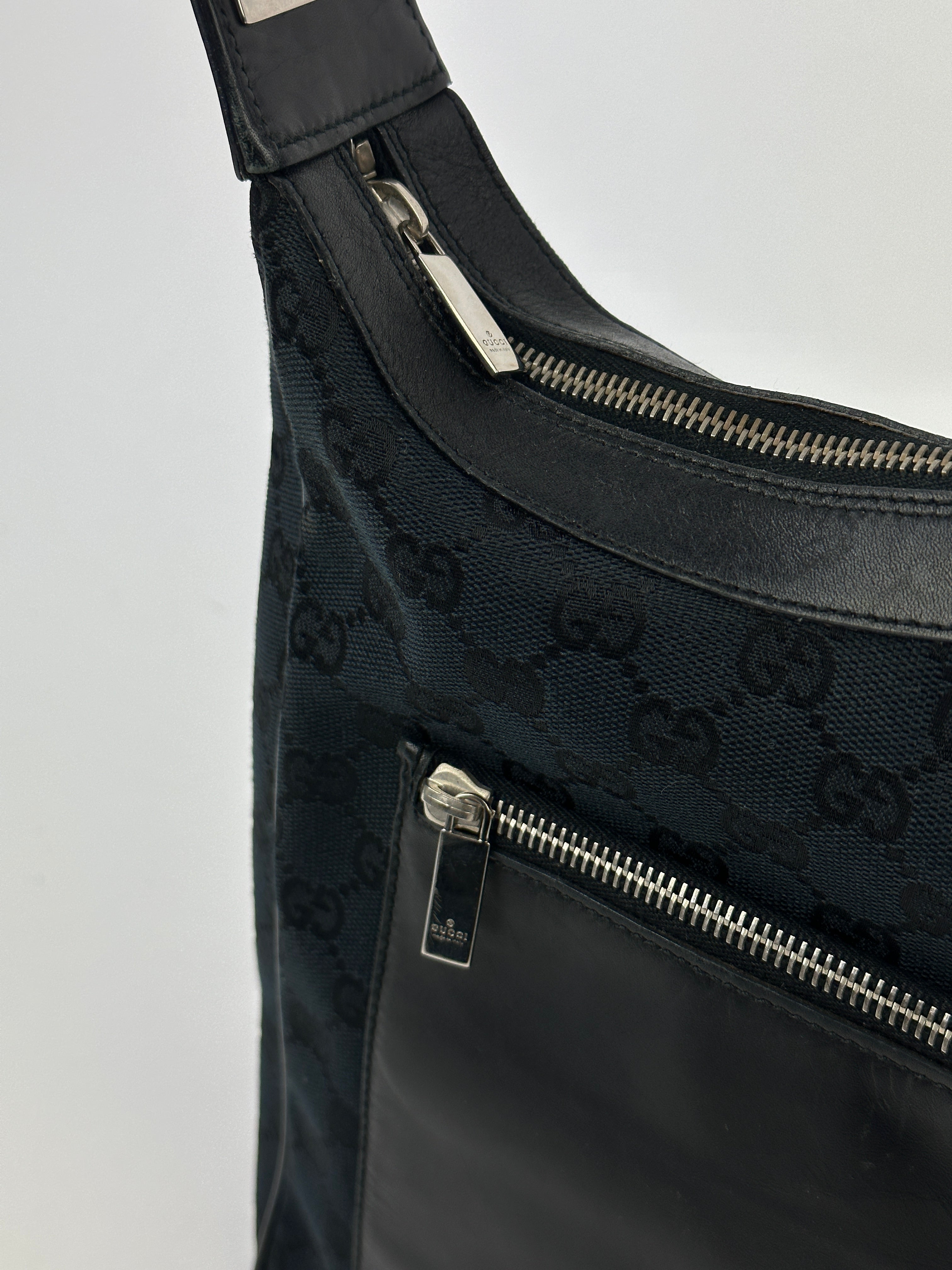Gucci GG Monogram Canvas Leather Shoulder Bag showing the monogram pattern and leather strap on a neutral background.