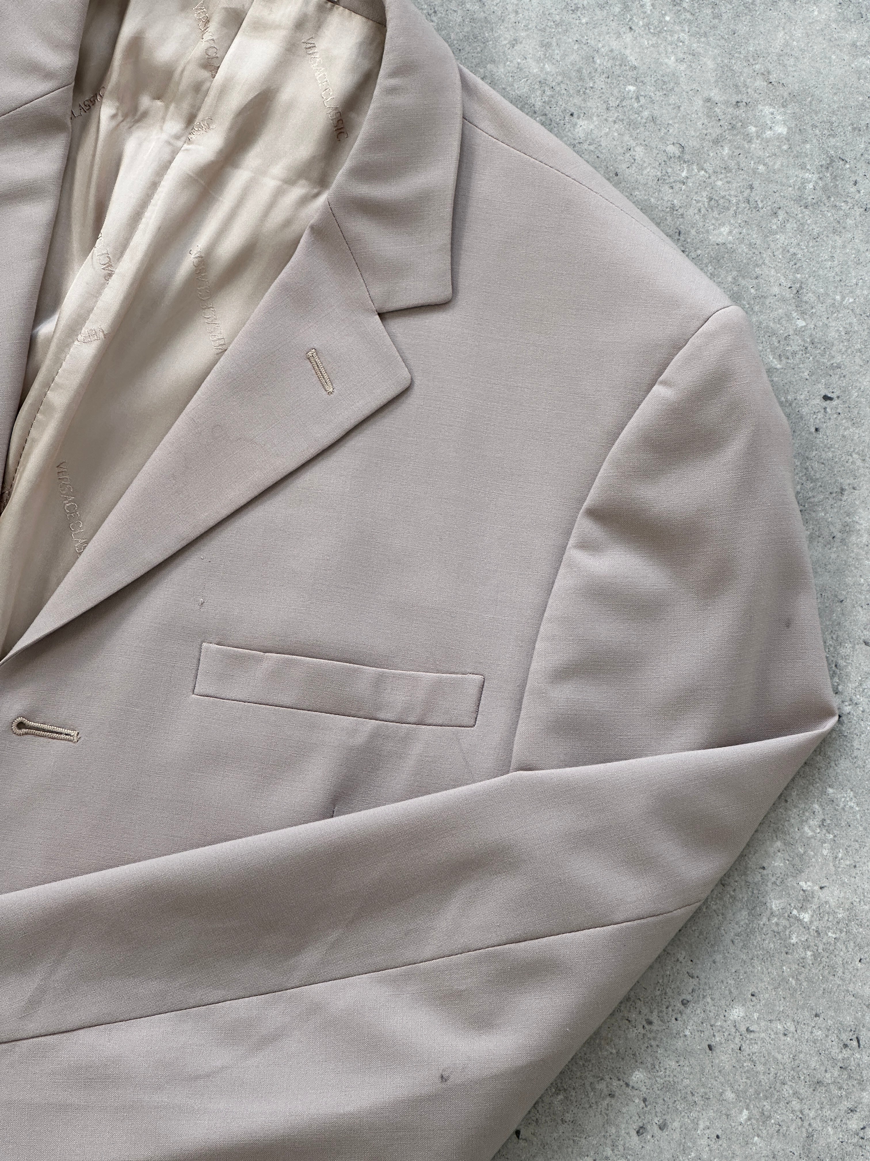 Versace single-breasted wool jumpsuit in size 42R/W30, featuring tailored fit and classic design, displayed on a neutral background.