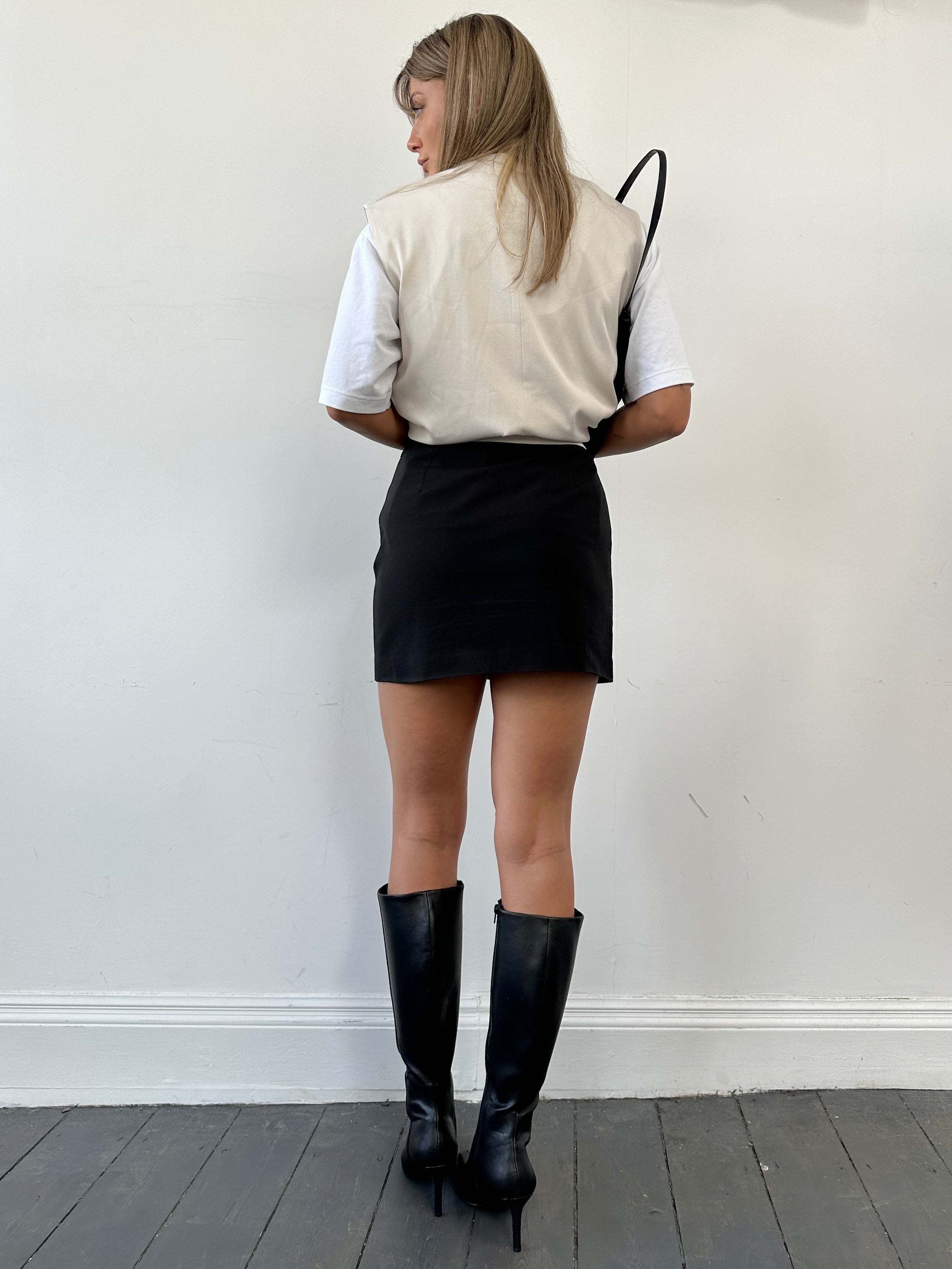 Vintage Italian mini skirt, W27, in classic style with detailed fabric and a timeless vintage design, shown on a hanger.