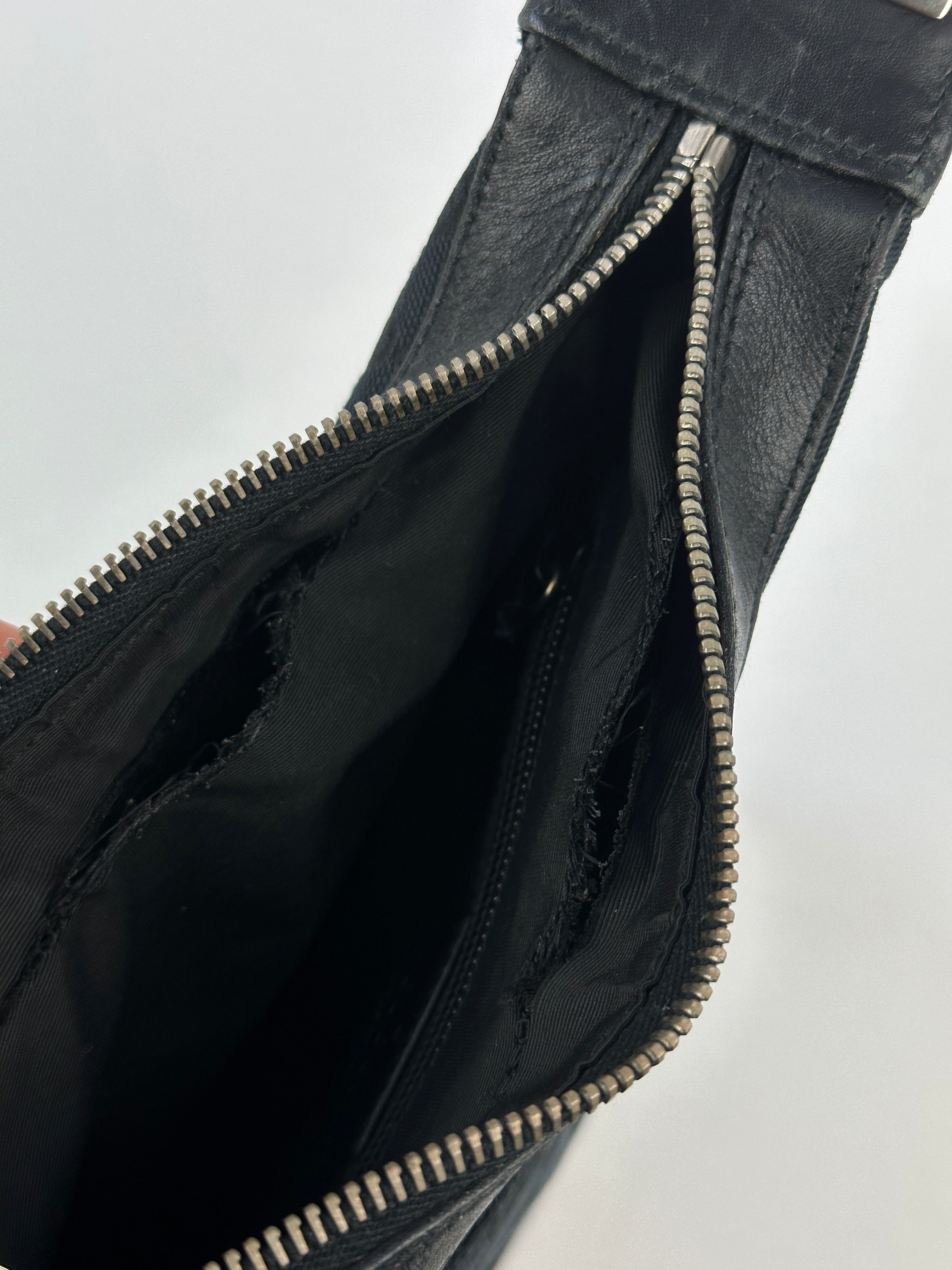 Gucci GG monogram canvas leather shoulder bag with adjustable strap and gold-tone hardware, stylish and spacious for everyday use.