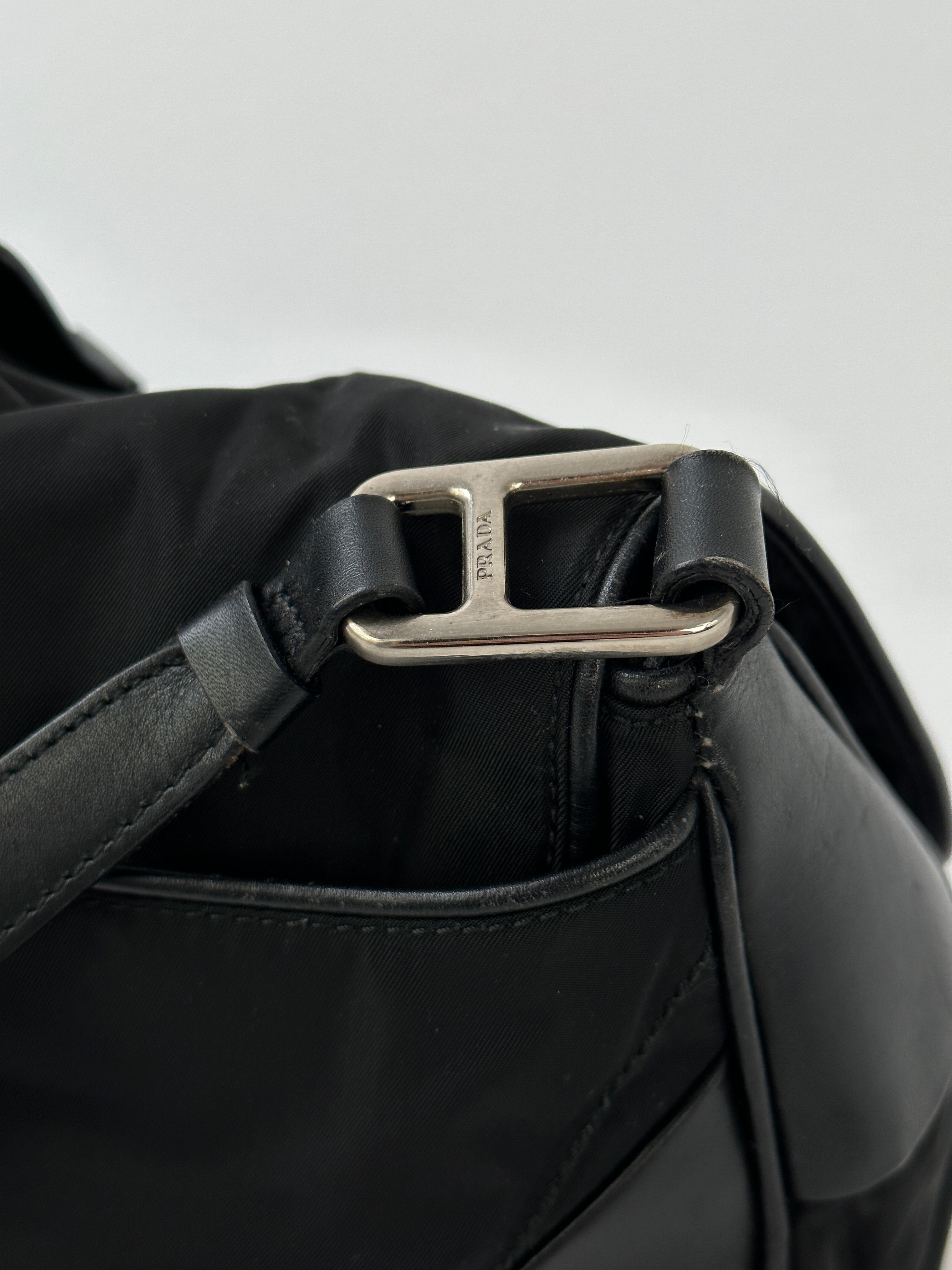 Prada 2000s Tessuto nylon double-sided shoulder bag with adjustable strap and Prada logo, featuring sleek black fabric design.