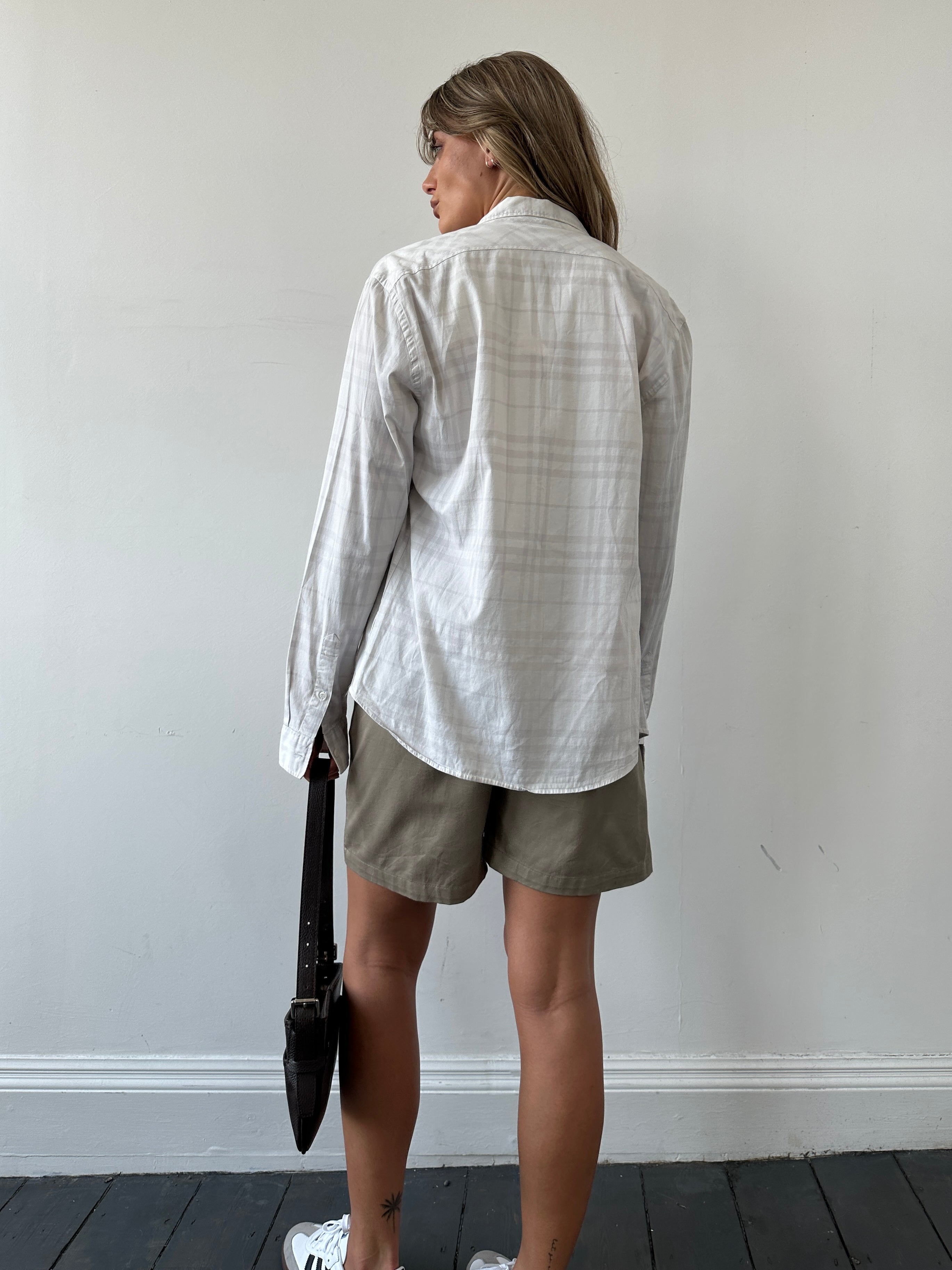 Burberry London Check cotton shirt in size S/M with classic plaid pattern and button-up front, displayed on a neutral background.