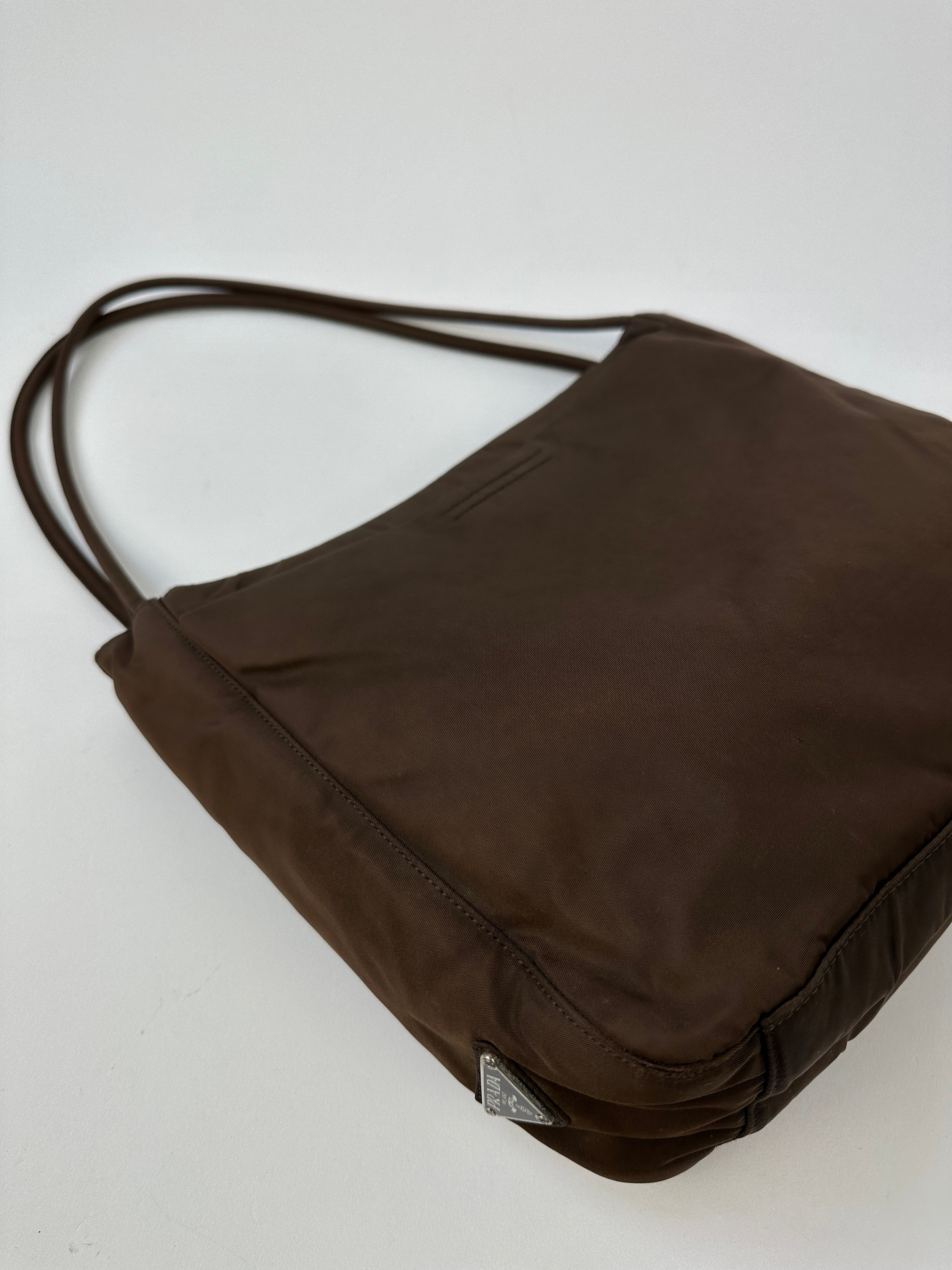 Prada Tessuto nylon tote bag with sleek design, featuring sturdy handles and spacious interior, perfect for everyday use.