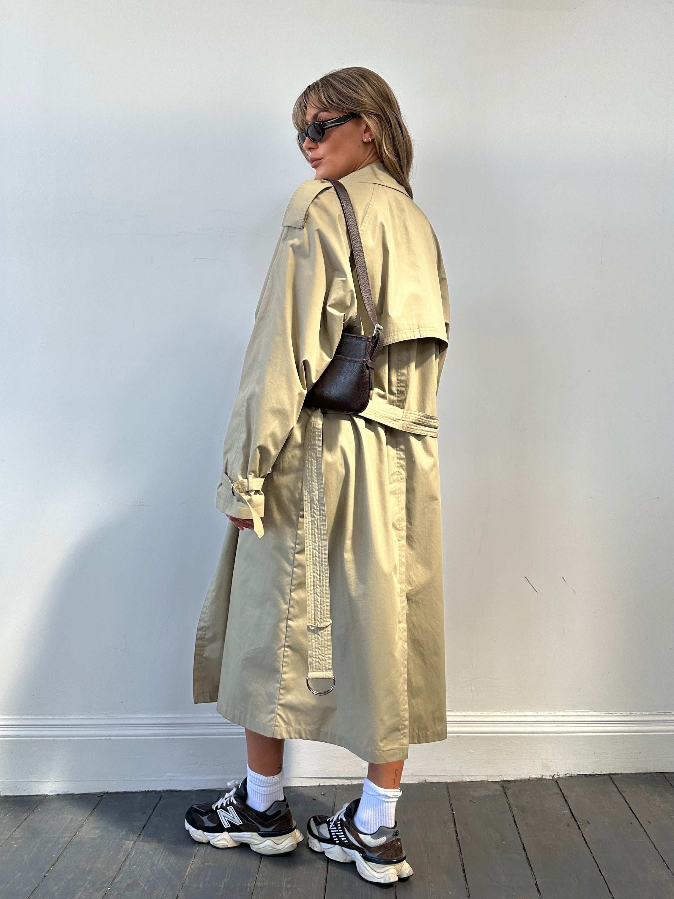Yves Saint Laurent double-breasted trench coat in size L/XL, beige color, tailored fit with classic lapels and belt detail.