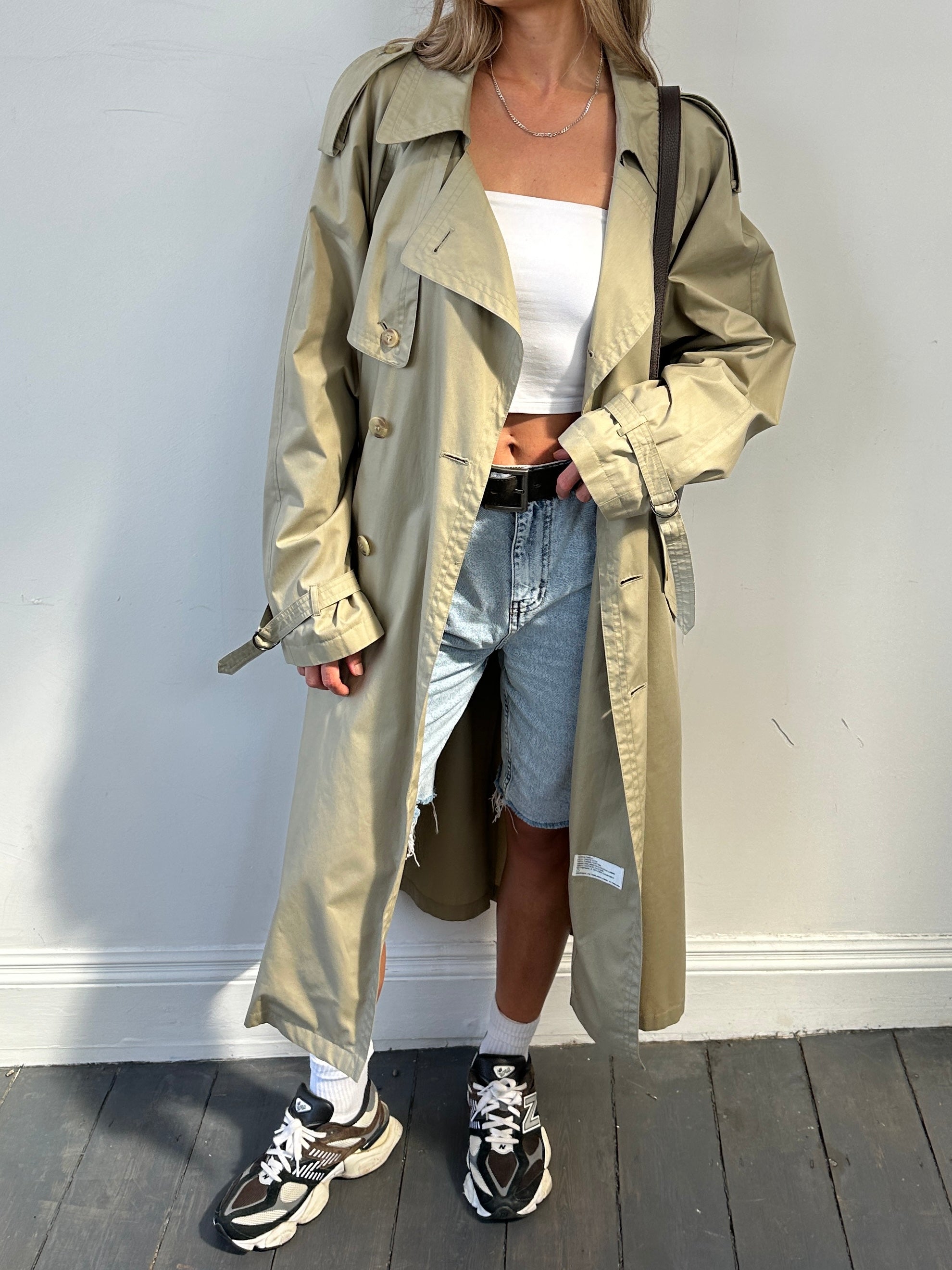 Yves Saint Laurent double-breasted trench coat in size L/XL, featuring classic design, belted waist, and tailored fit.
