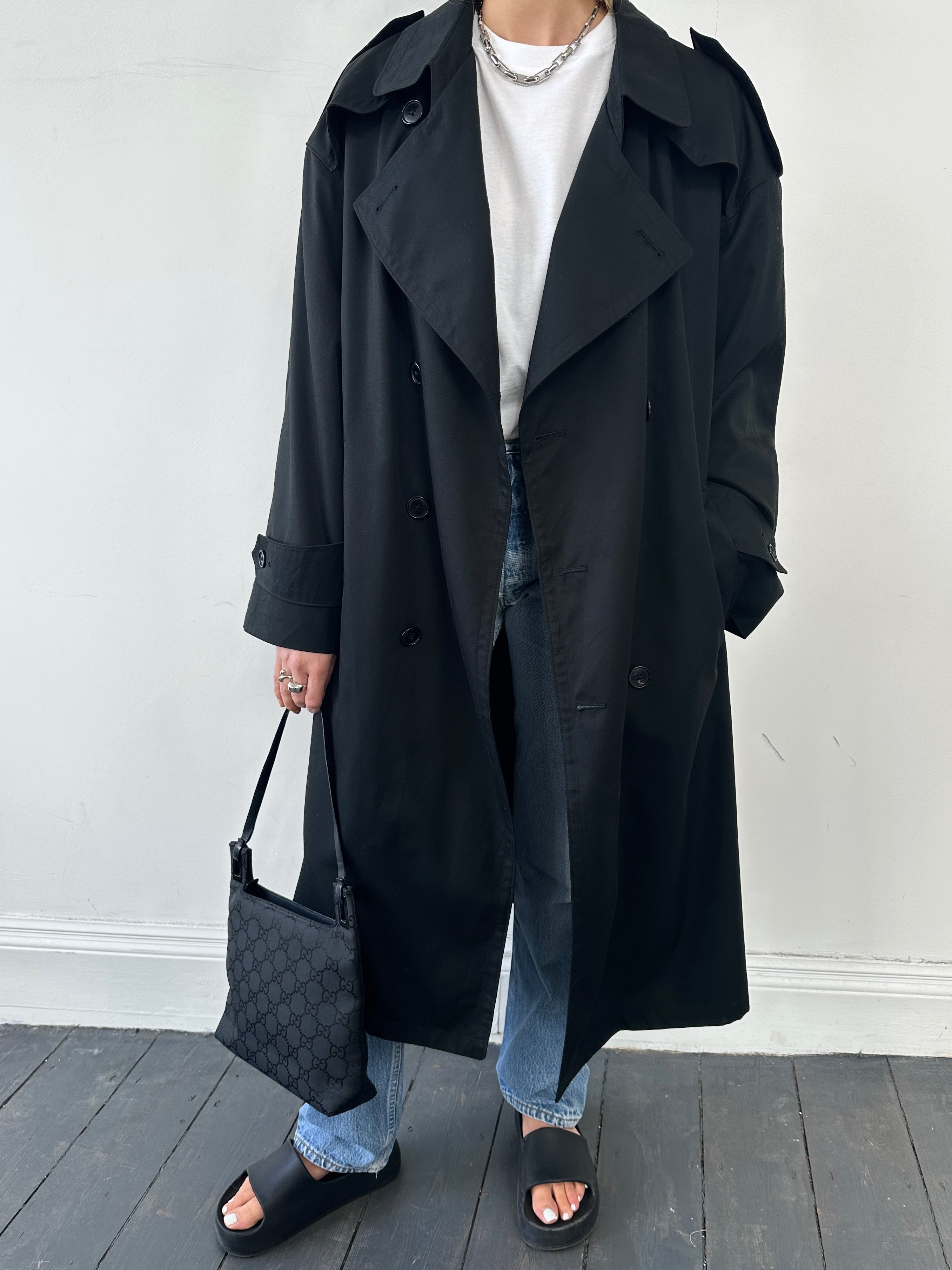 Christian Dior Monsieur double-breasted trench coat in beige, tailored fit with classic lapels and belt, displayed on a hanger.