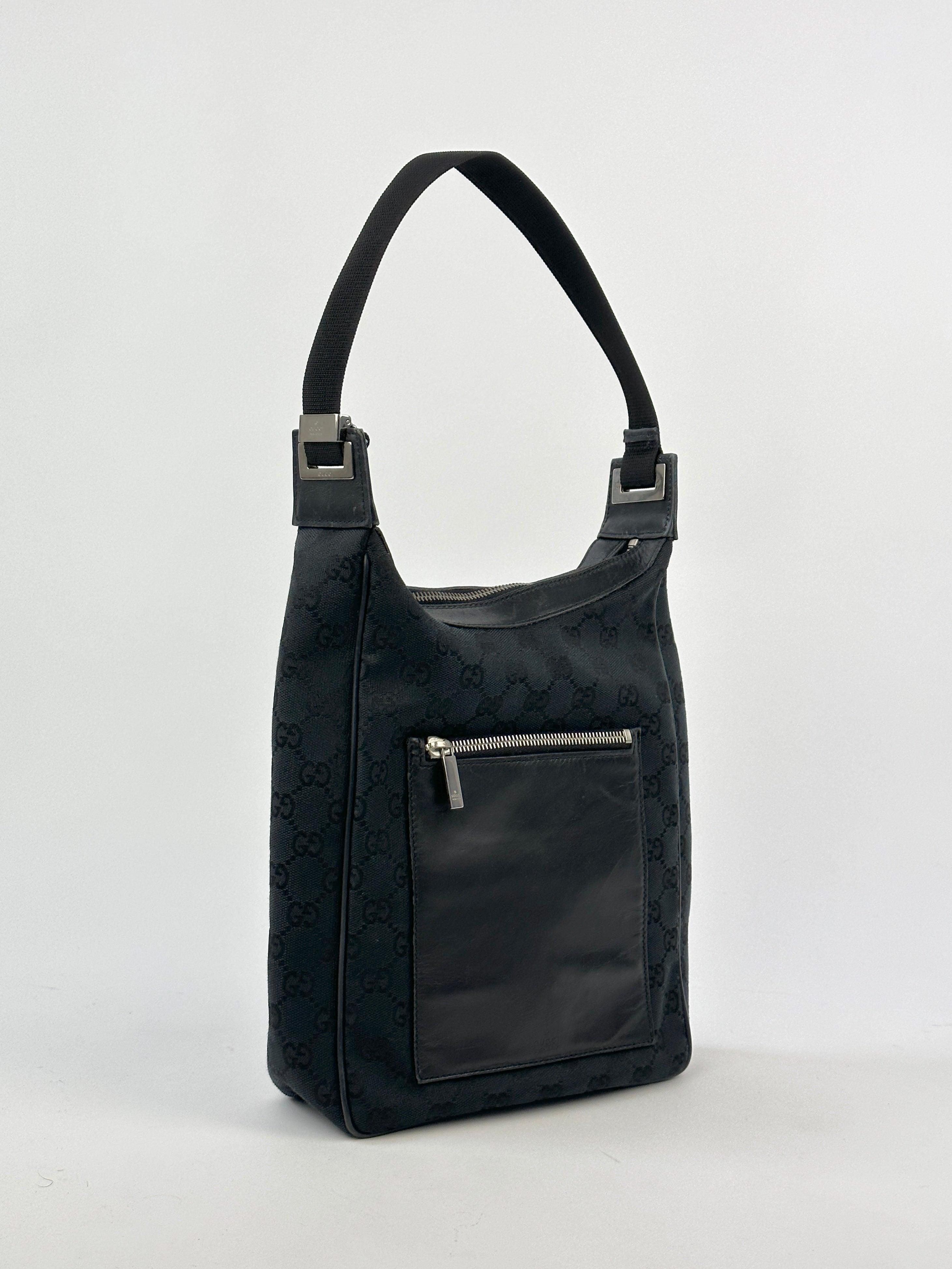Gucci GG Monogram Canvas Leather Shoulder Bag featuring a spacious design, leather accents, and adjustable shoulder strap.