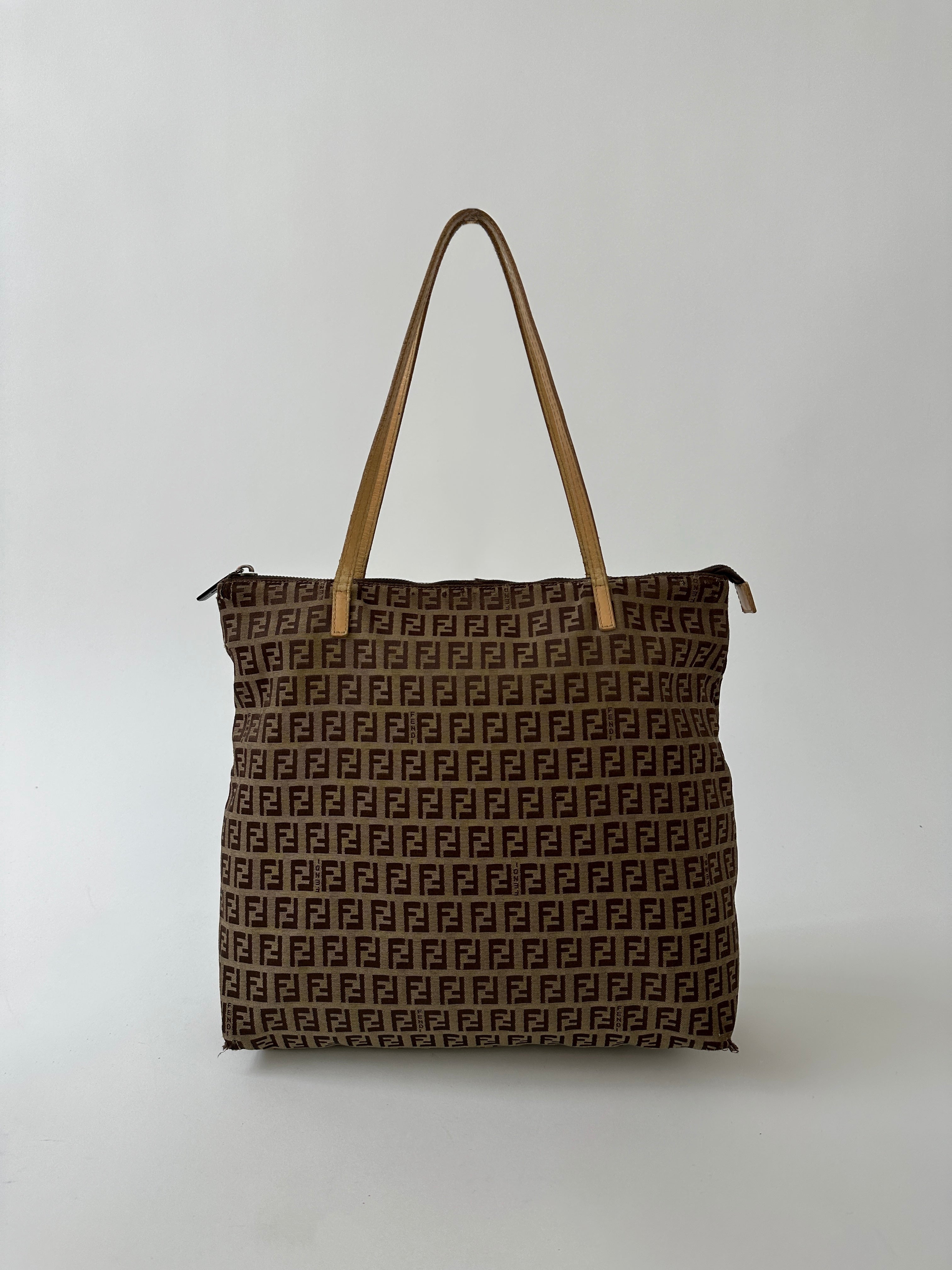 Fendi FF Monogram shoulder bag with adjustable strap and gold-tone hardware, featuring signature monogram fabric.