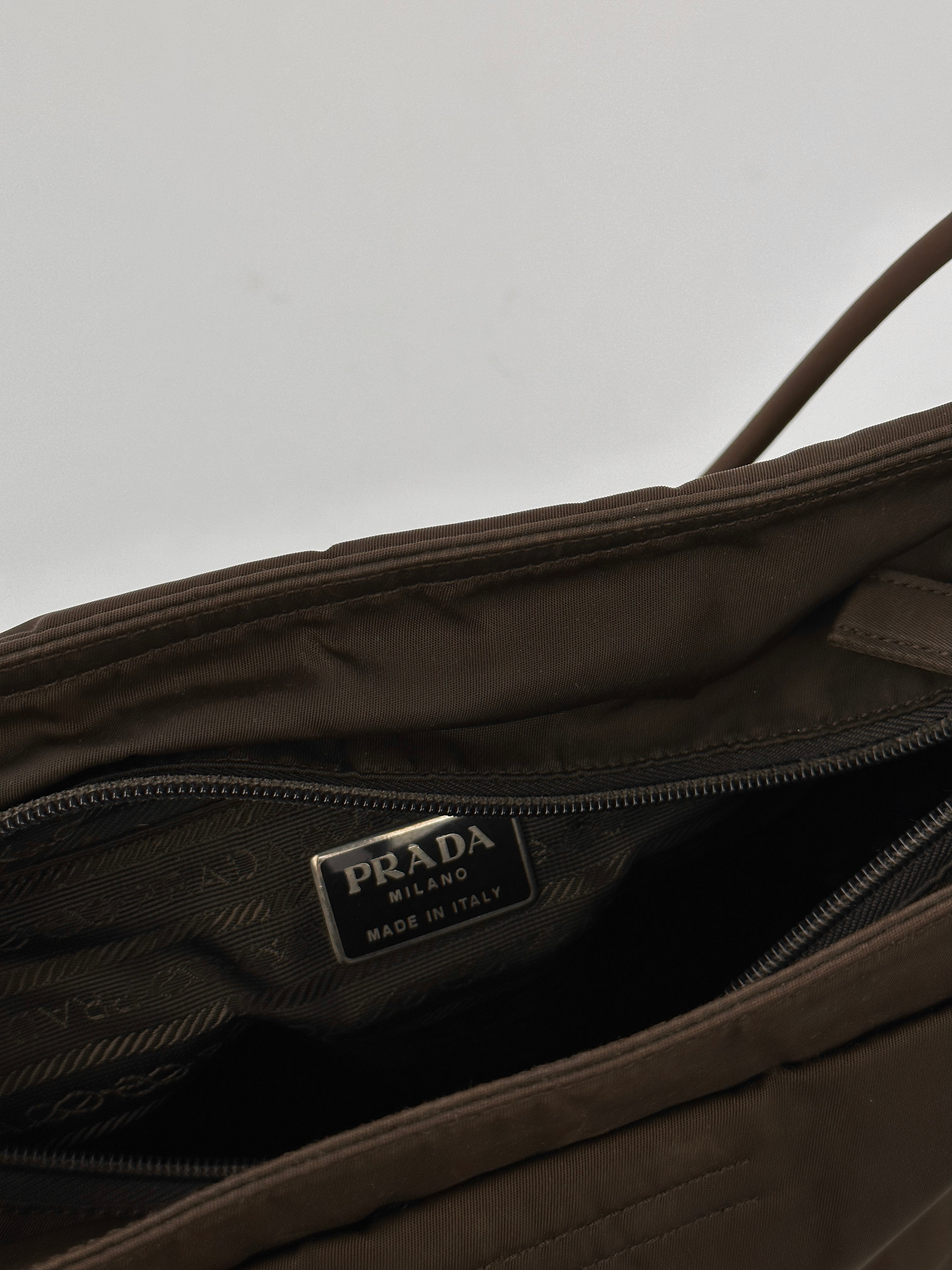 Prada Tessuto nylon tote bag with double handles and spacious interior, showcasing sleek design and durable fabric.