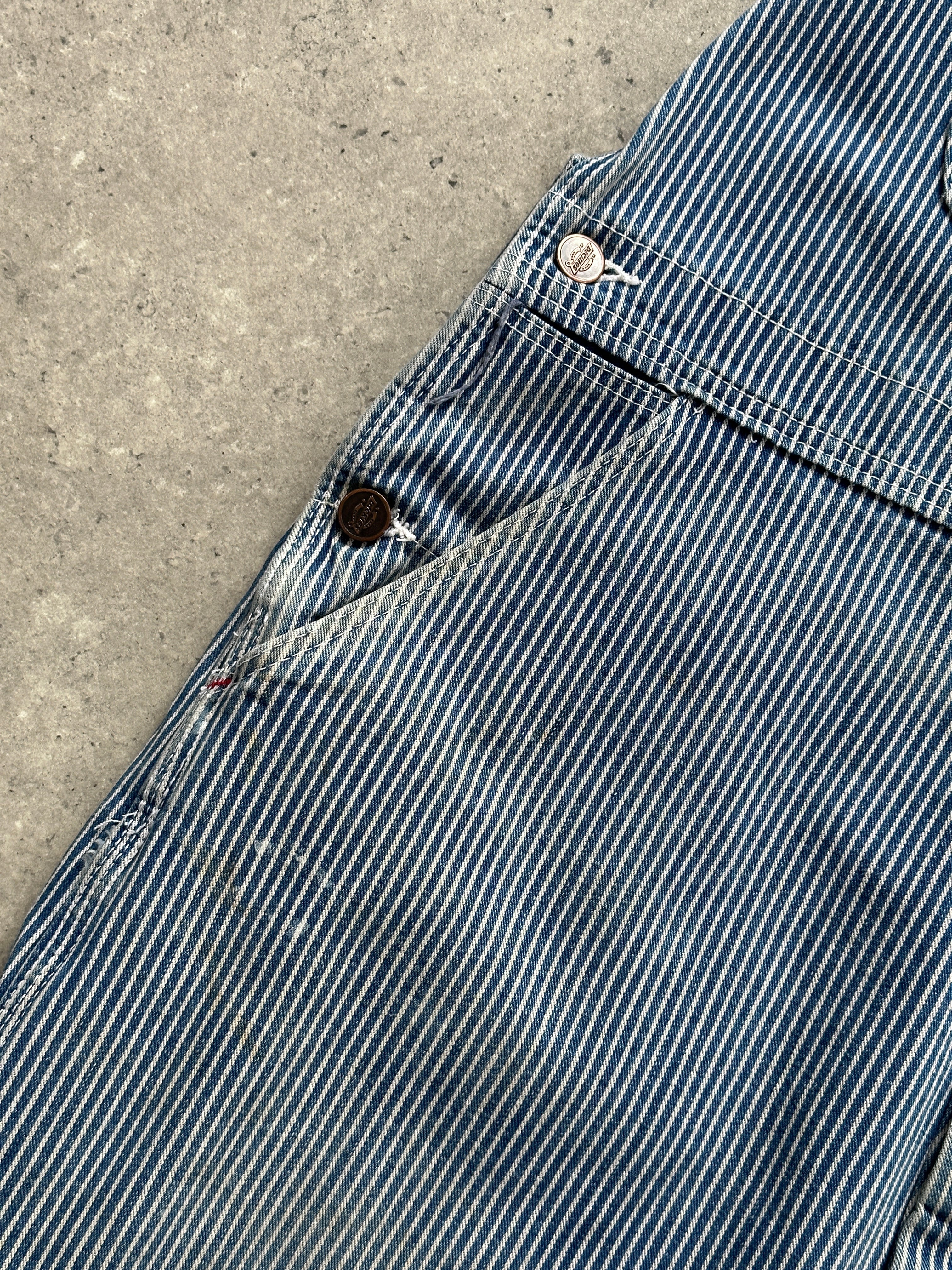 Dickies pinstripe pure cotton dungarees in size M/L, featuring adjustable straps and front pockets, on a plain background.