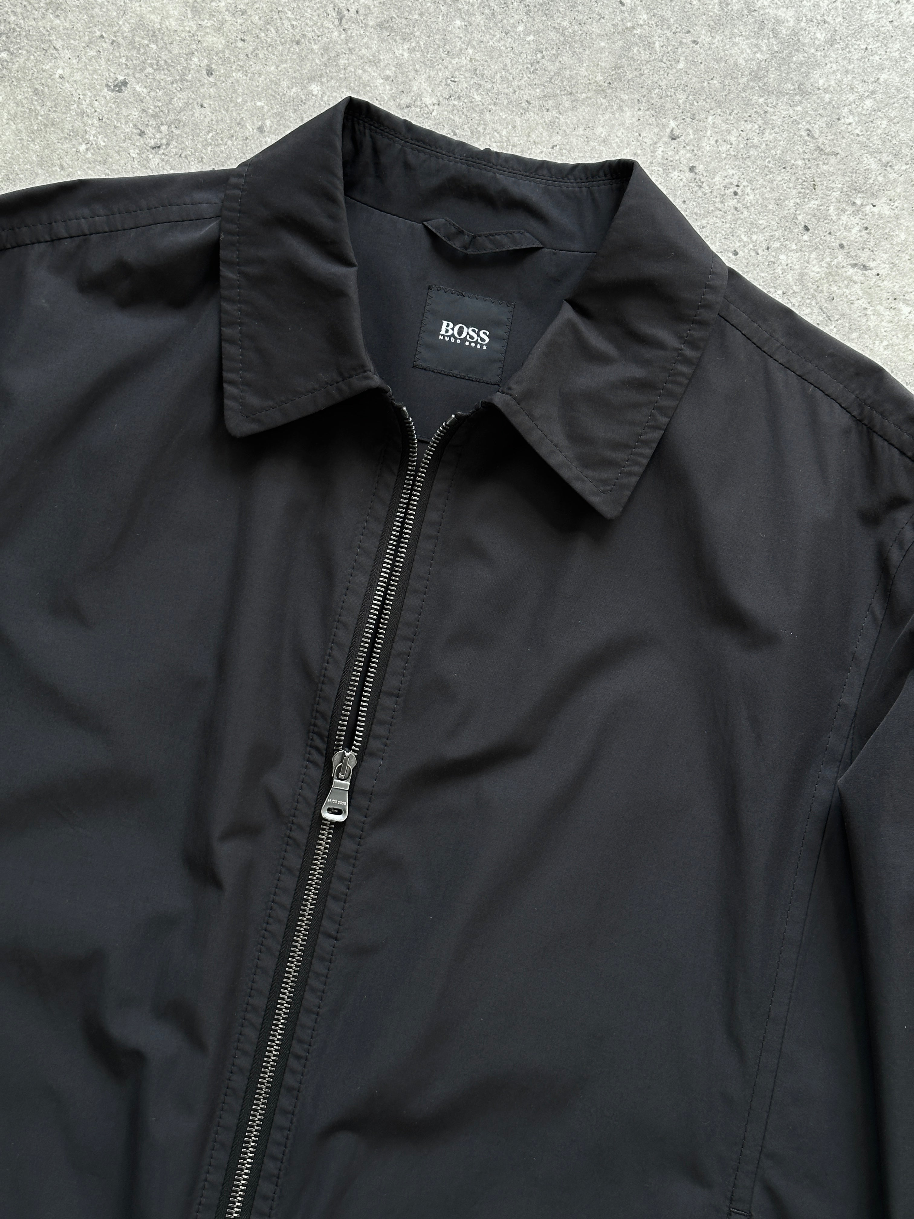 Hugo Boss Minimal Zip Up Jacket in size L, men's stylish jacket with sleek design and front zipper, black color, close-up view.