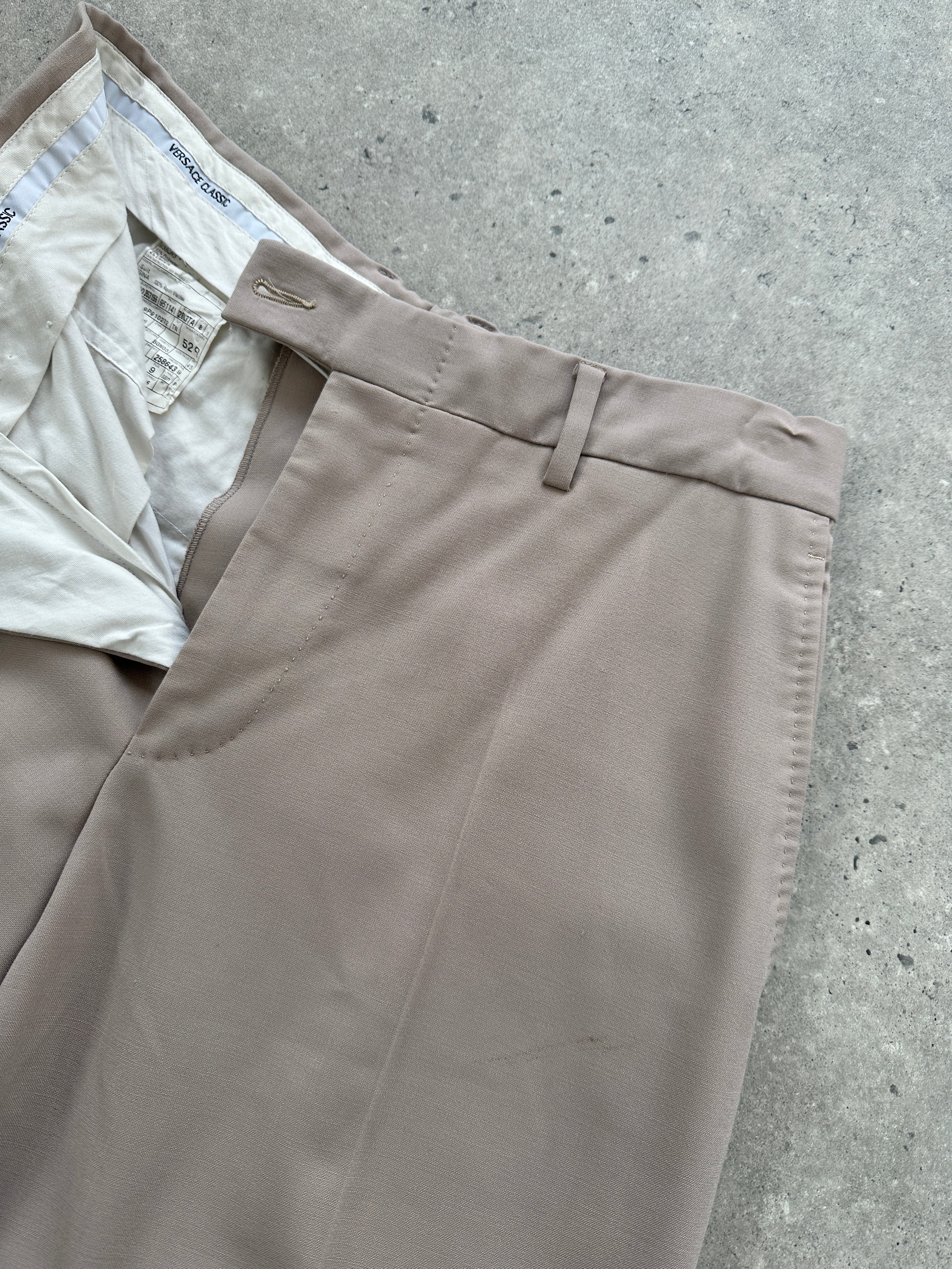 Versace single-breasted wool jumpsuit in size 42R/W30, tailored fit with classic lapel and sleek design.