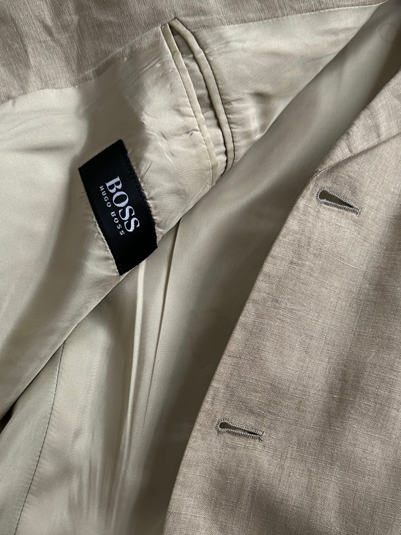 Hugo Boss boxy pure linen single-breasted blazer in XL, shown in a neutral color, tailored fit with lapel collar and front buttons.