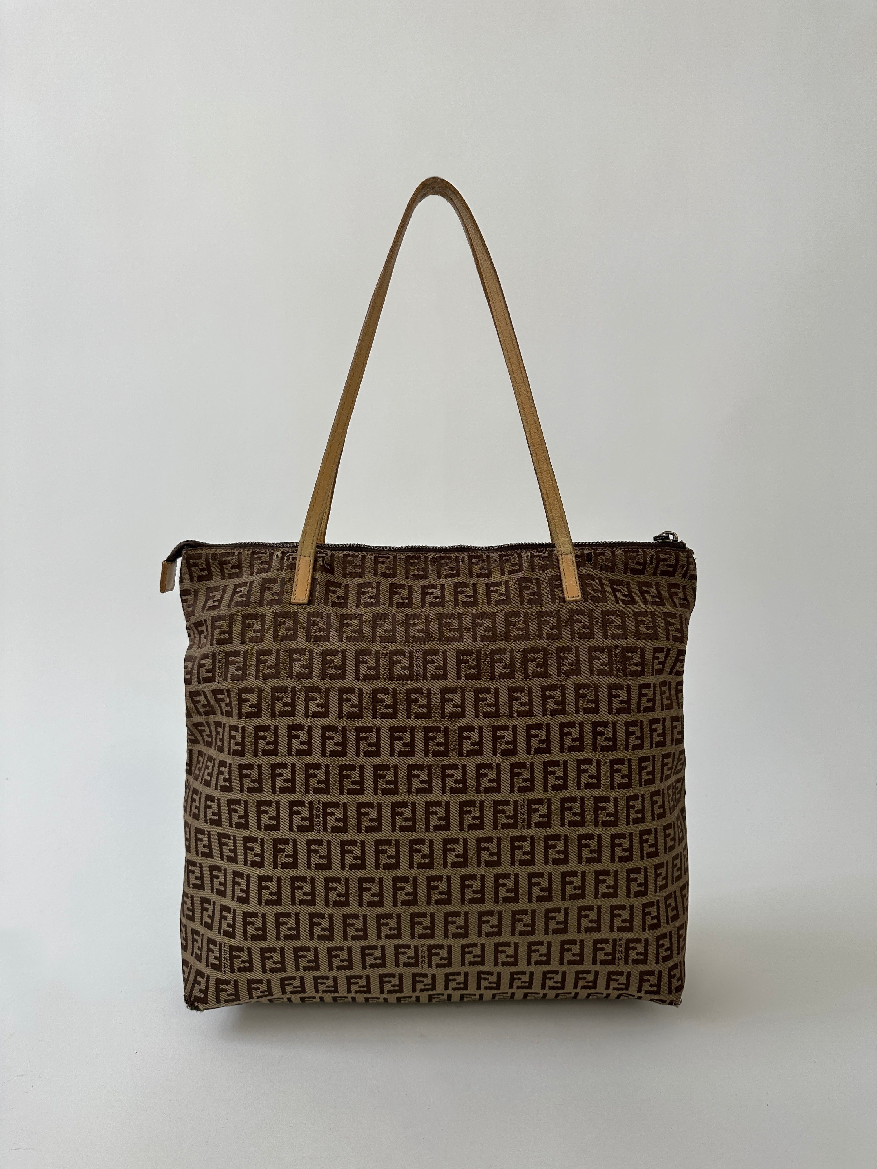 Fendi FF Monogram shoulder bag with leather strap and gold-tone hardware, featuring signature Fendi monogram pattern.