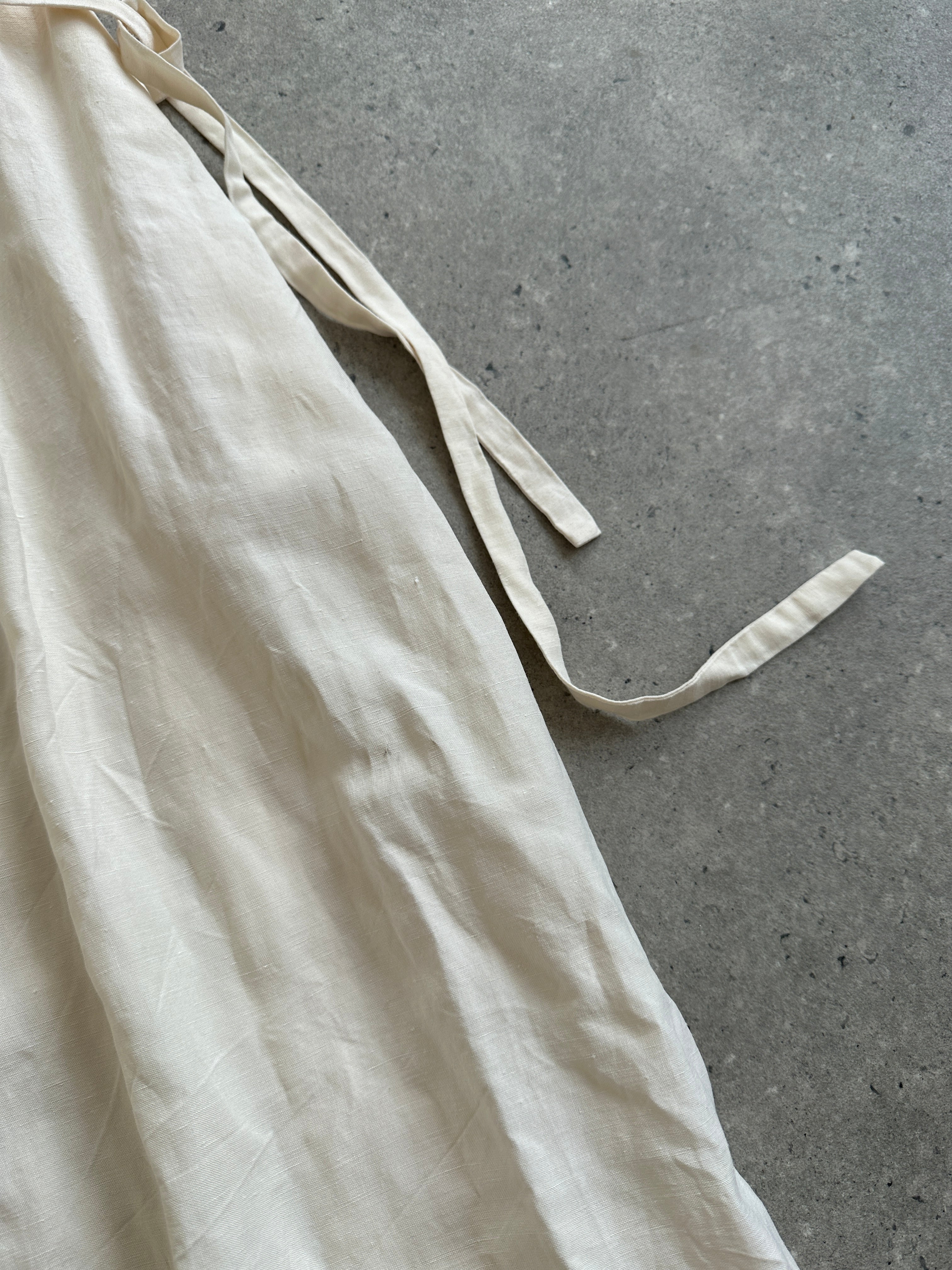 Laura Ashley silk linen maxi wrap dress in S/M, featuring flowy fabric and a stylish design, displayed on a hanger.