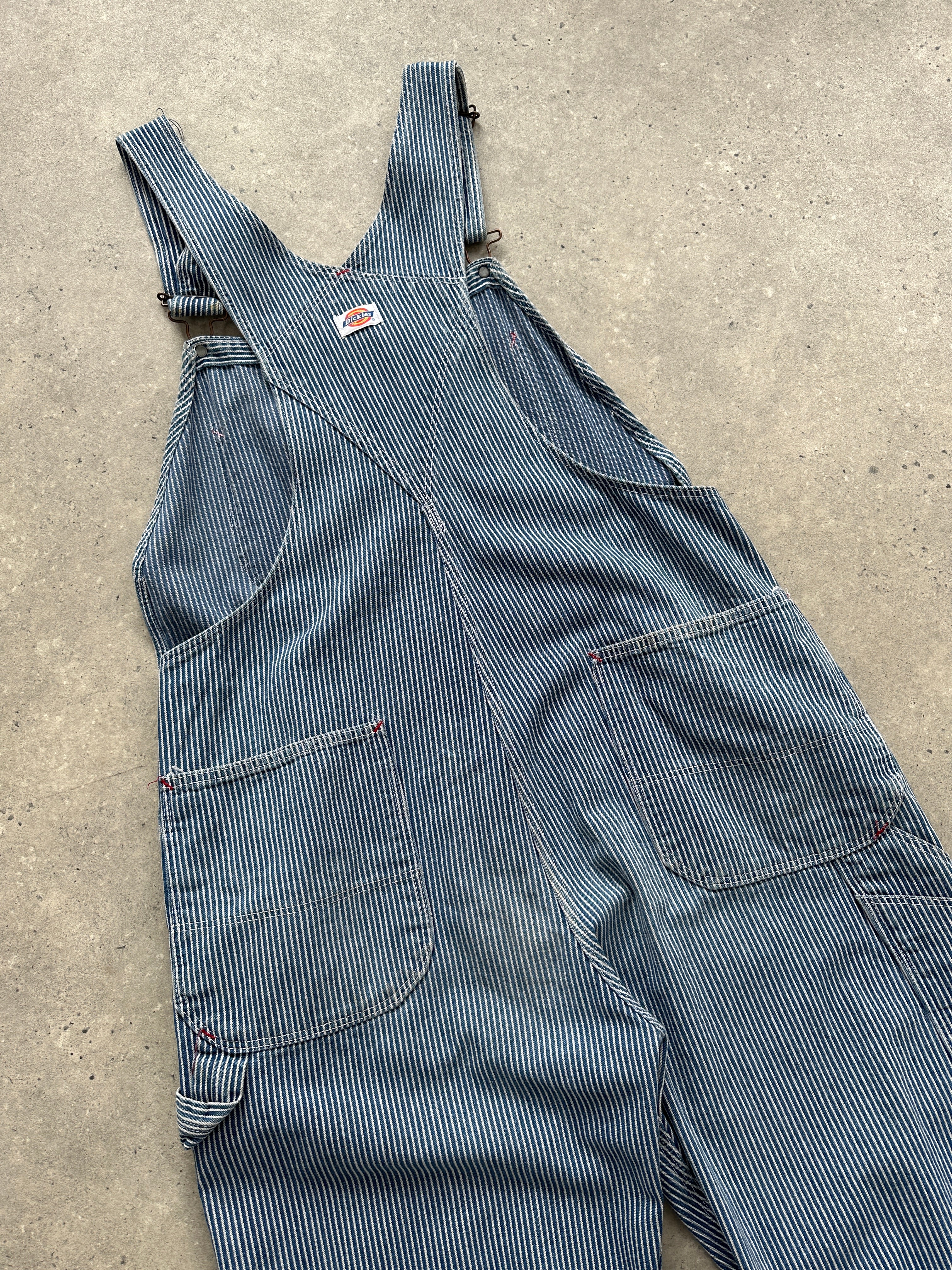 Dickies pinstripe pure cotton dungarees in size M/L, showing the classic bib and adjustable shoulder straps on a neutral background.