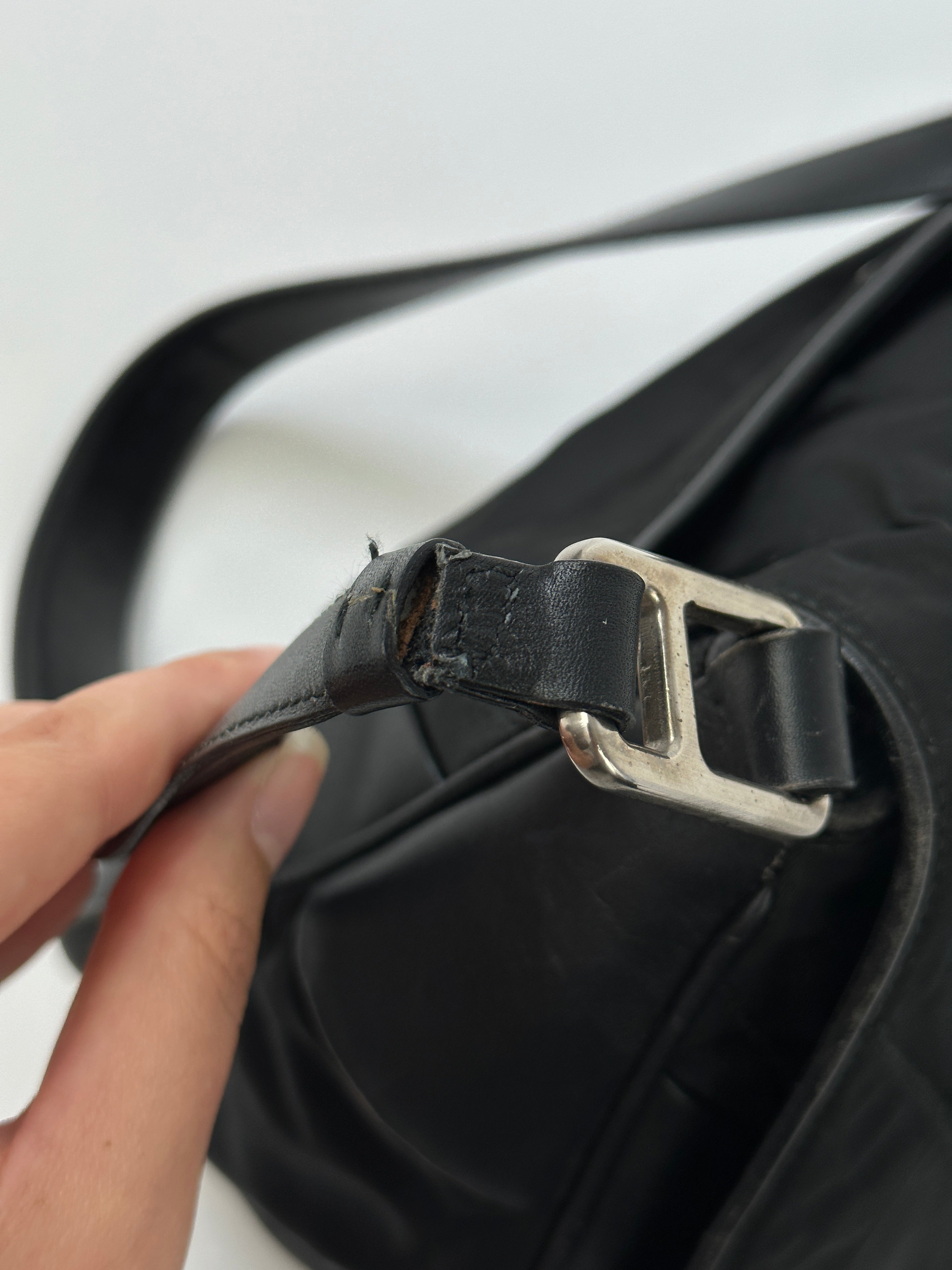Prada 2000s Tessuto nylon double-sided shoulder bag with adjustable strap and sleek design.