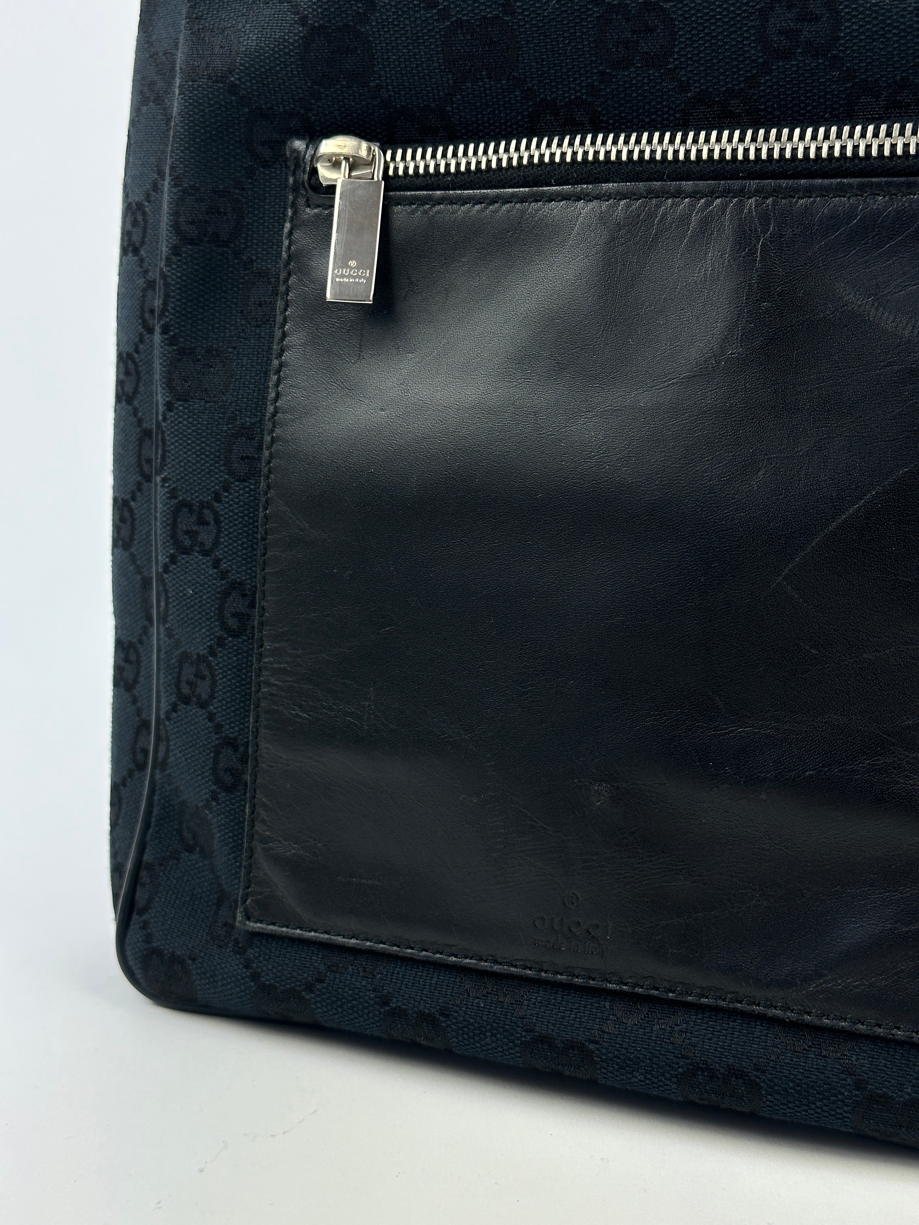 Gucci GG Monogram Canvas Leather Shoulder Bag showing the signature pattern, leather accents, and adjustable shoulder strap.