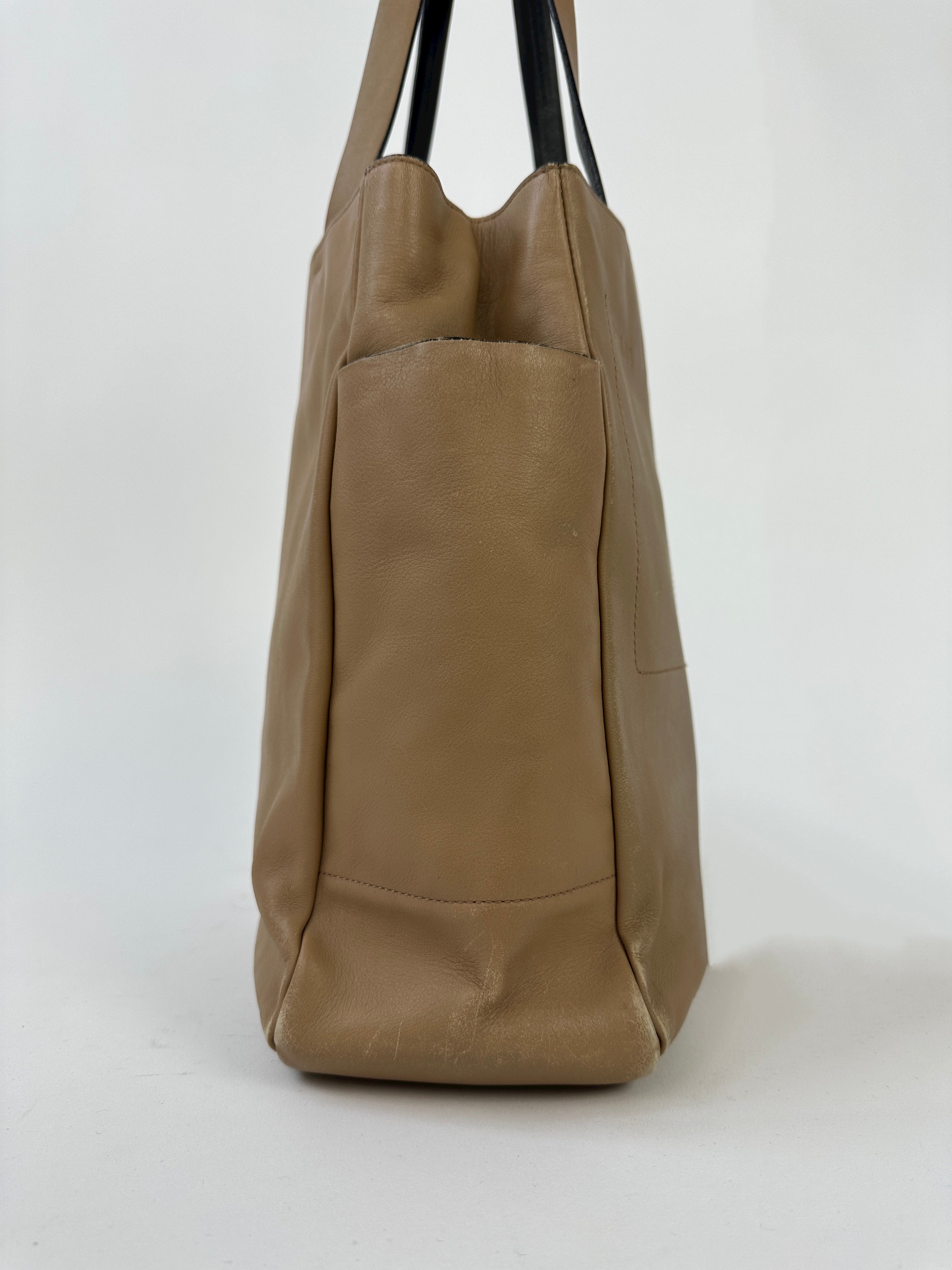 Prada contrast leather tote bag with structured design, featuring dual handles and a spacious interior for everyday use.