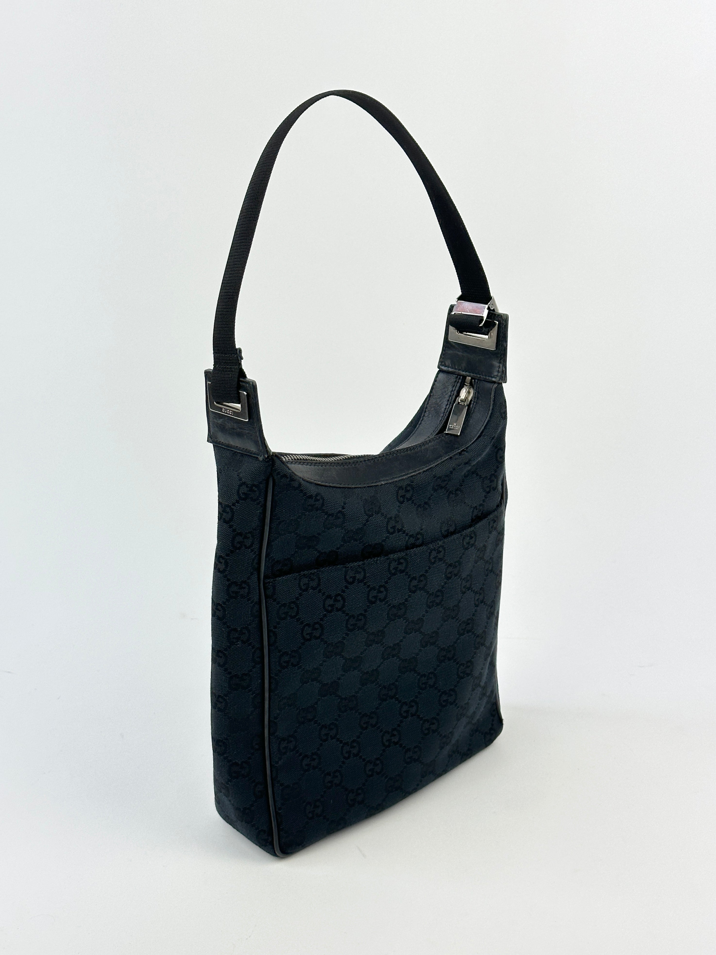 Gucci GG Monogram Canvas Leather Shoulder Bag with adjustable strap and gold-tone hardware, featuring signature pattern and leather accents.