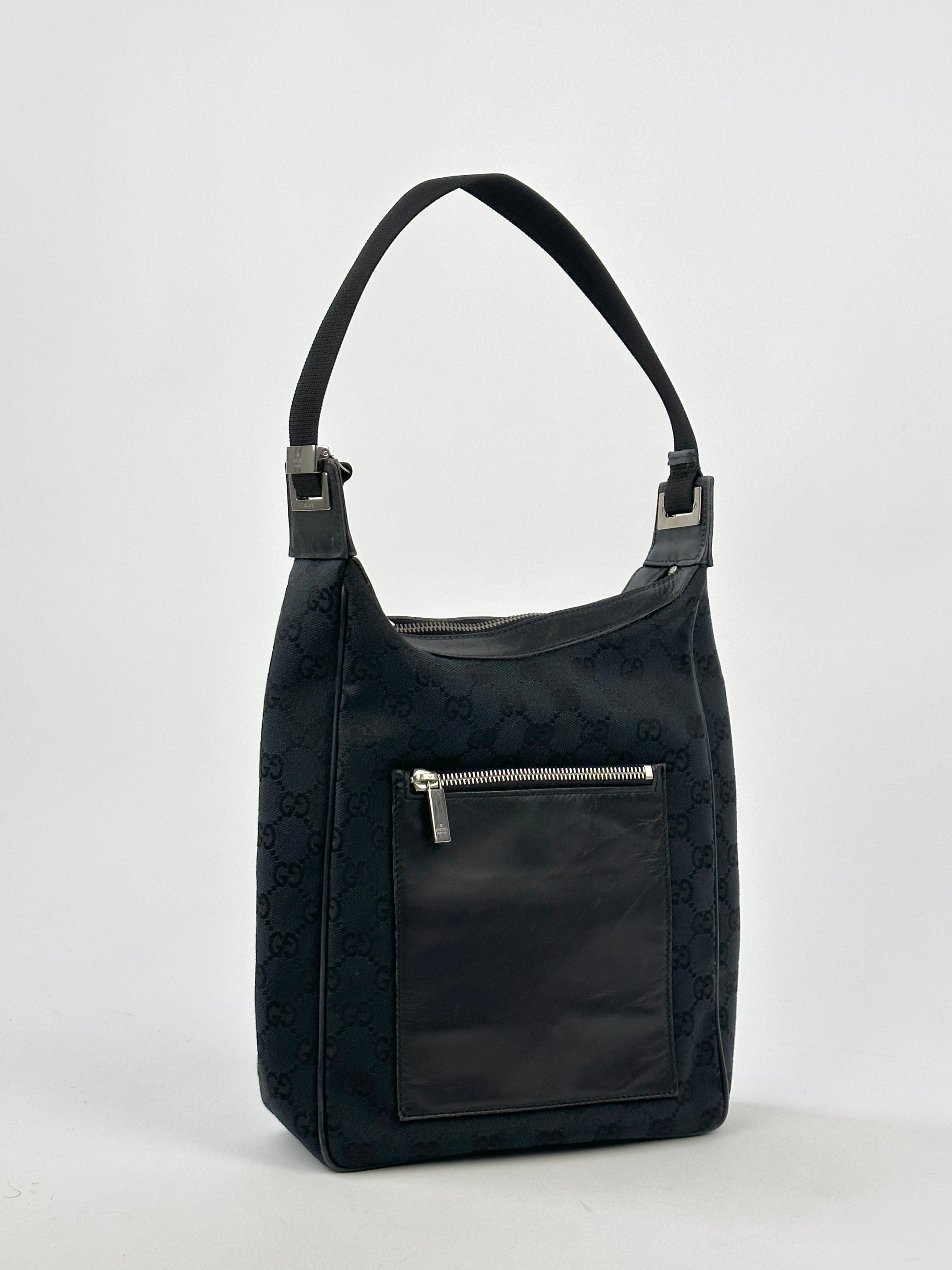 Gucci GG Monogram Canvas Leather Shoulder Bag with adjustable strap and gold-tone hardware, stylish and spacious for everyday use.
