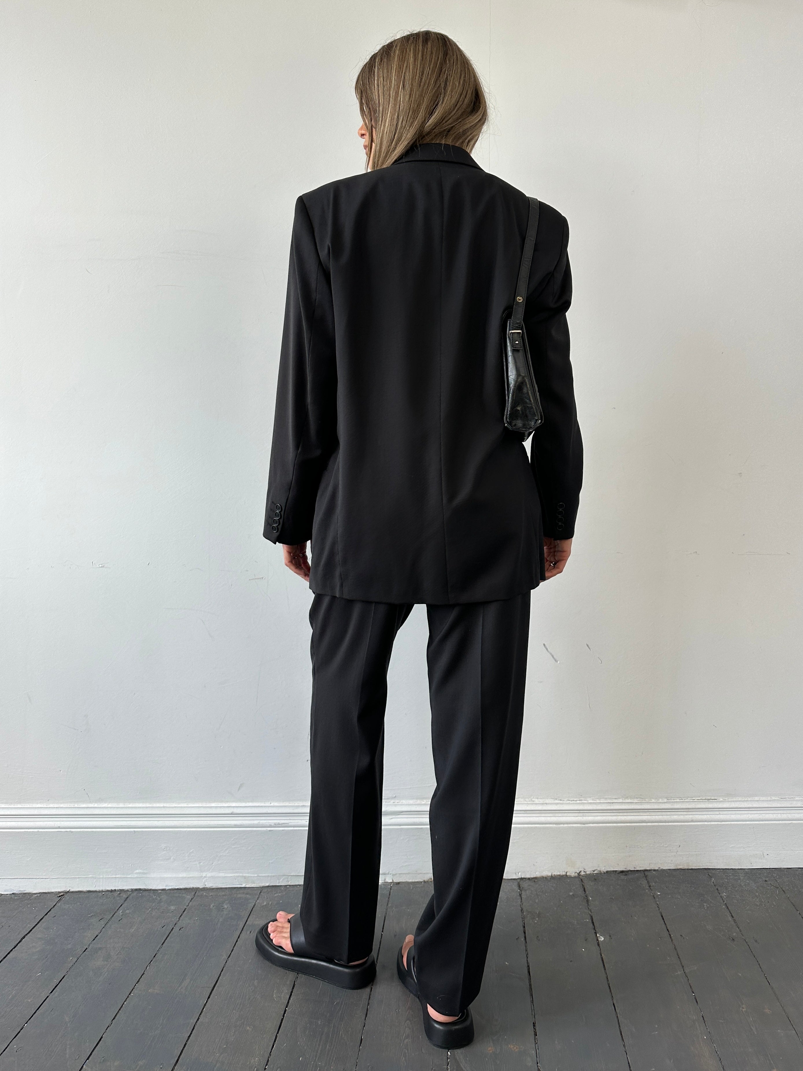 Pierre Cardin pure wool single-breasted suit jumpsuit in size 40R/W34, shown on a hanger with detailed fabric texture.
