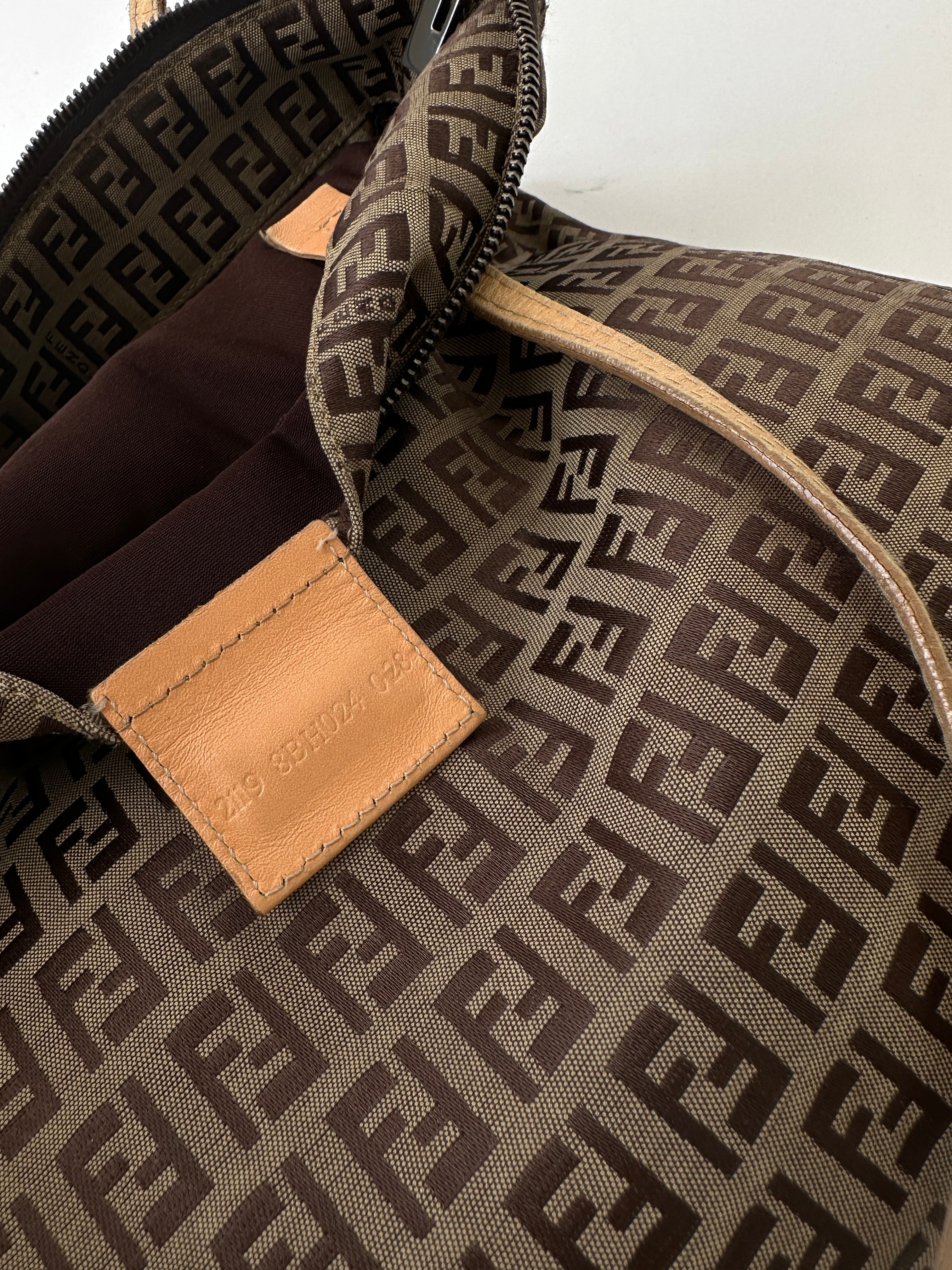 Fendi FF Monogram Shoulder Bag showing the iconic logo pattern, leather strap, and compact design on a plain background.