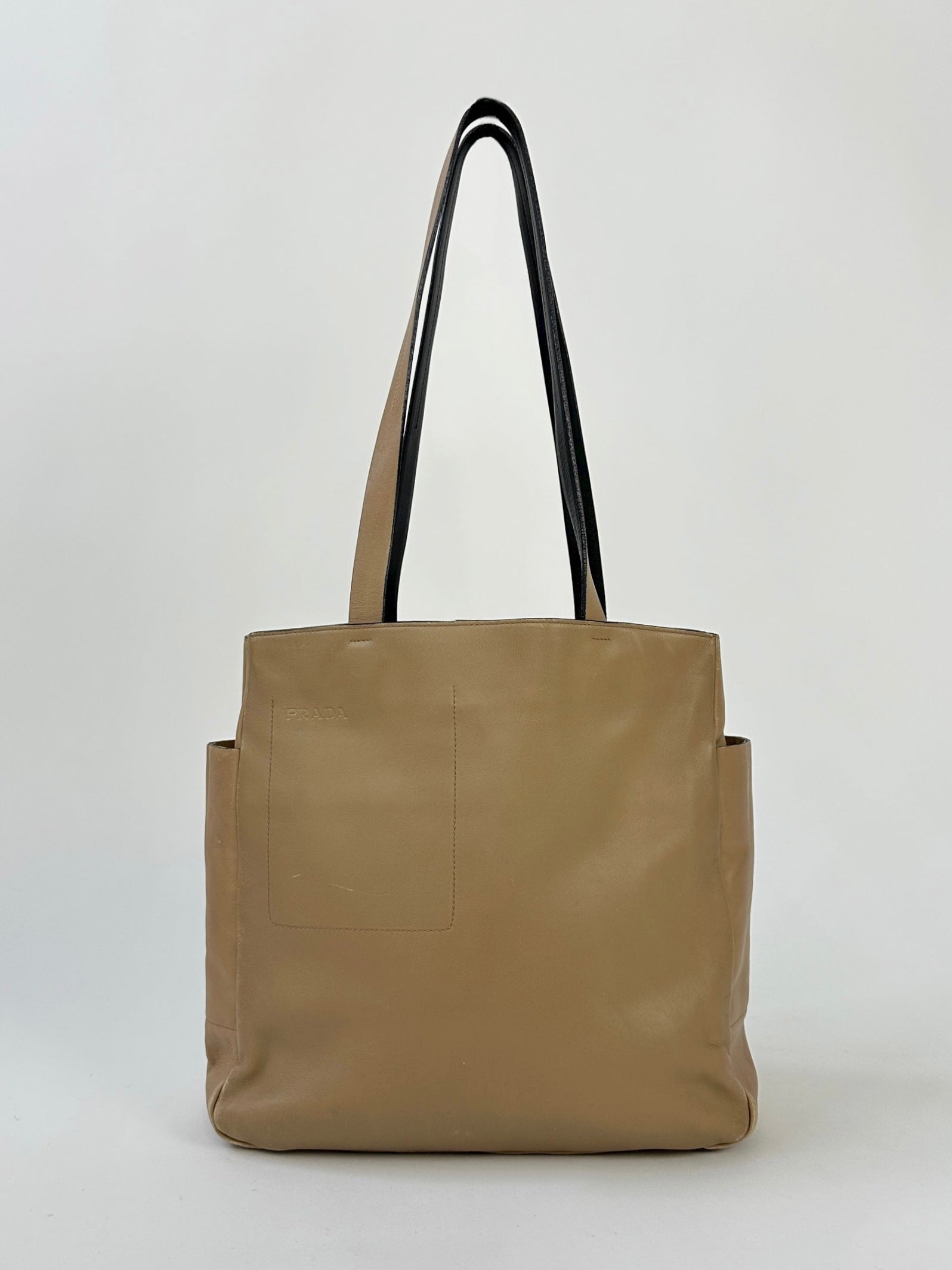 Prada contrast leather tote bag with sleek design, featuring smooth leather and spacious interior for everyday use.
