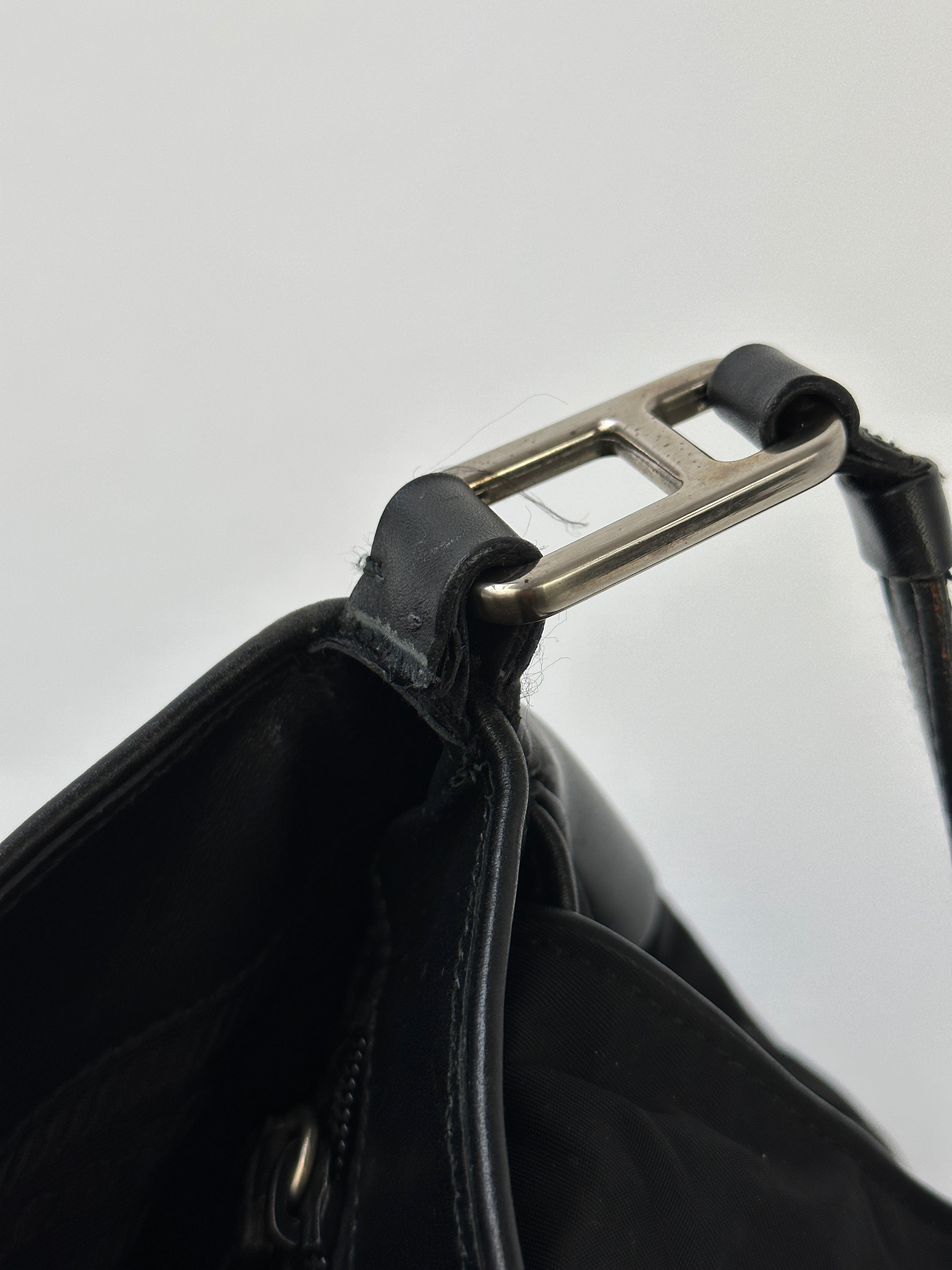 Prada 2000s Tessuto Nylon double-sided shoulder bag with adjustable strap and sleek design, featuring Prada branding.